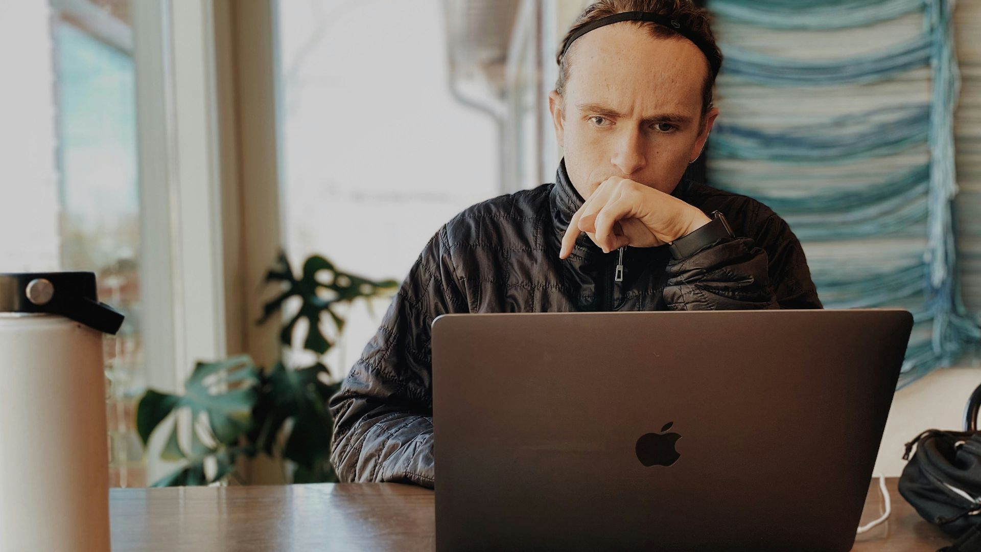 a man sitting in front of a laptop computer