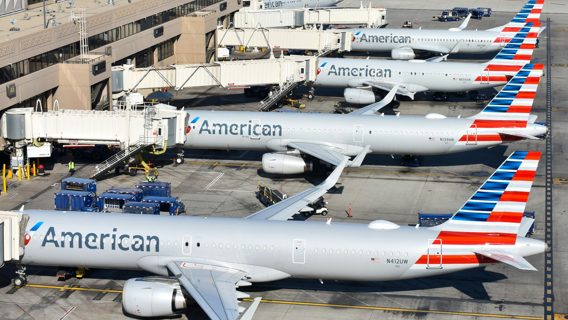 A group of american airlines planes parked at an airport