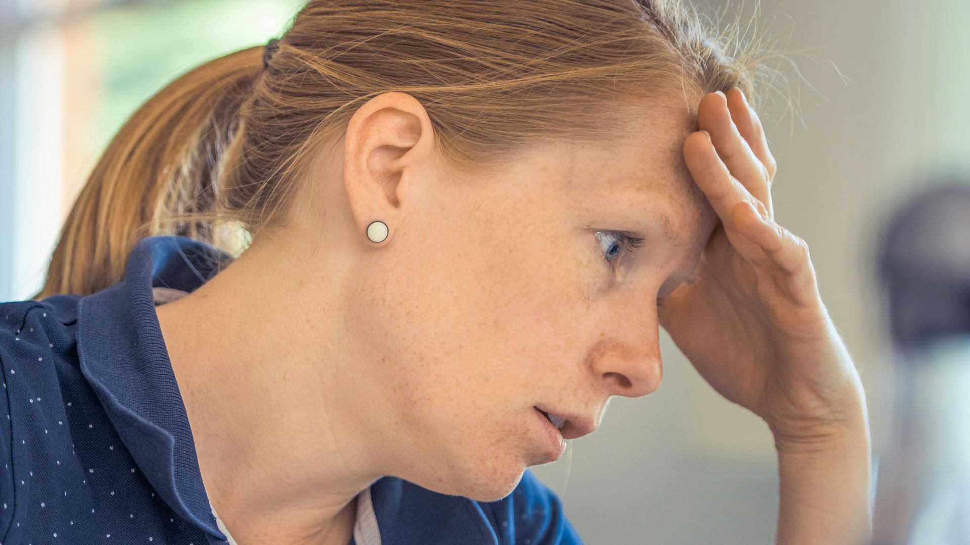 Businesswoman showing stress and concentration while working at her desk.