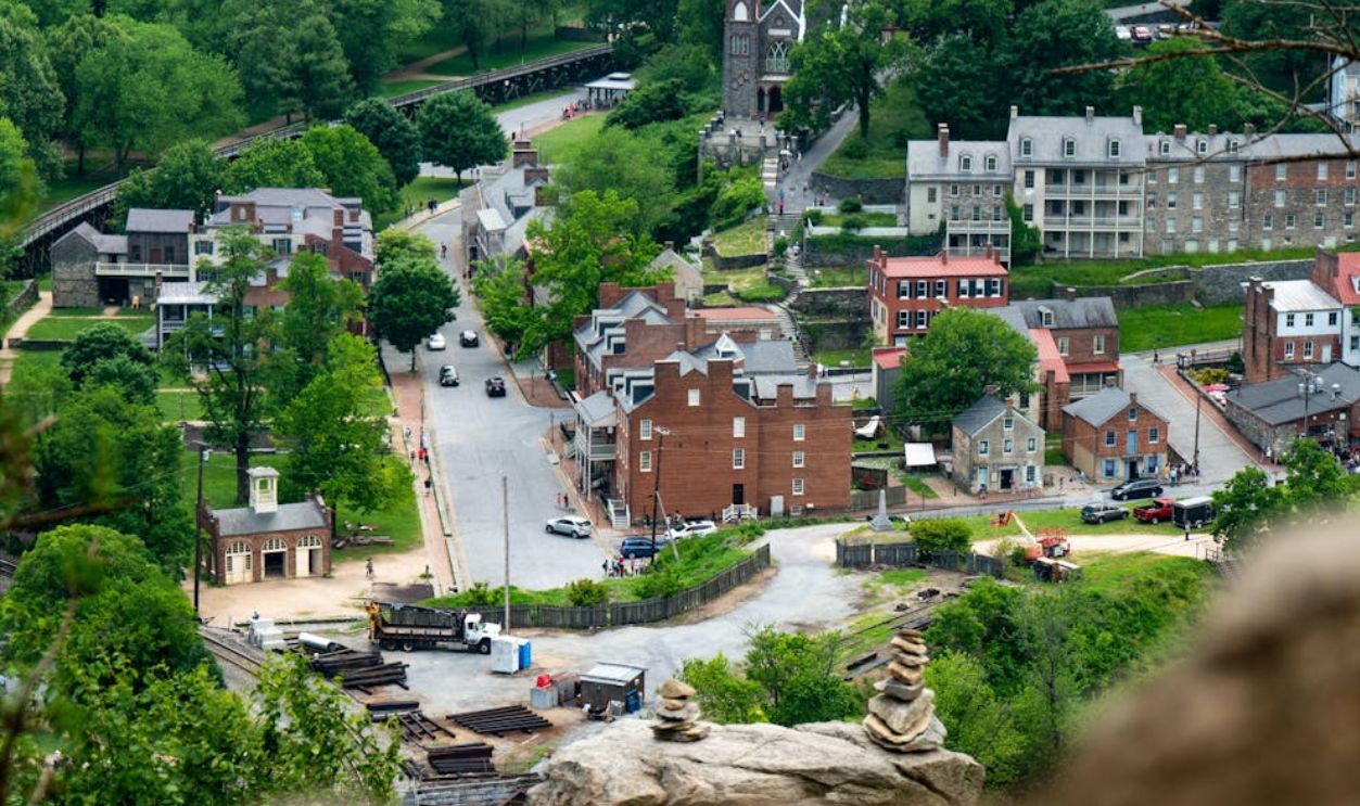 Aerial view of Harpers Ferry, showcasing historic buildings surrounded by lush greenery