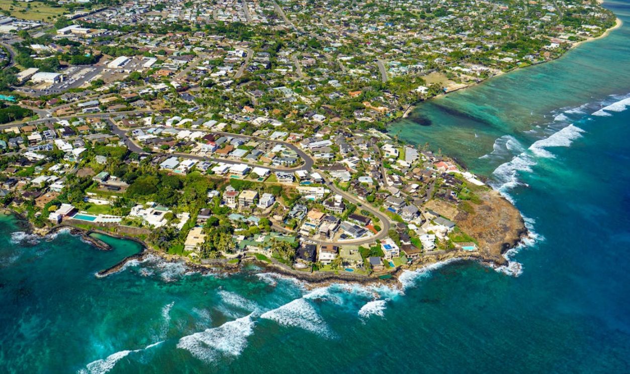 Scenic aerial view of Honolulu's coastline, capturing vibrant tropical cityscape and crystal clear waters
