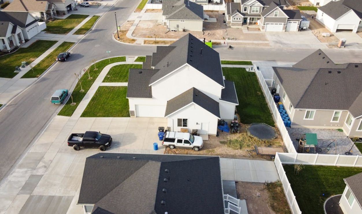 Aerial view of a residential suburban neighborhood in Spanish Fork, Utah with houses and vehicles parked on driveways