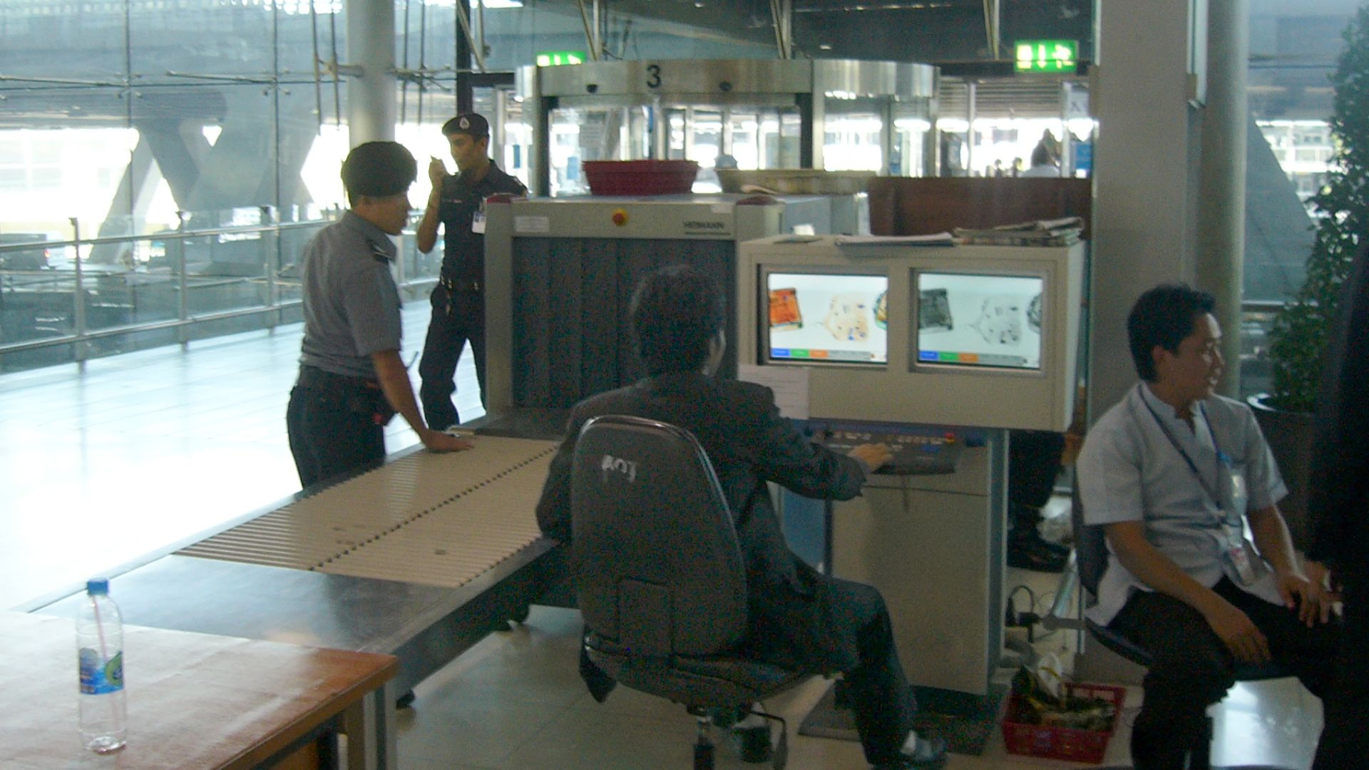 Luggage screening device at Suvarnabhumi International Airport, Bangkok, Thailand. This security post is located for entering the airport which means all people (visitors and passengers) have to pass such a control. Another control will be for boarding lu