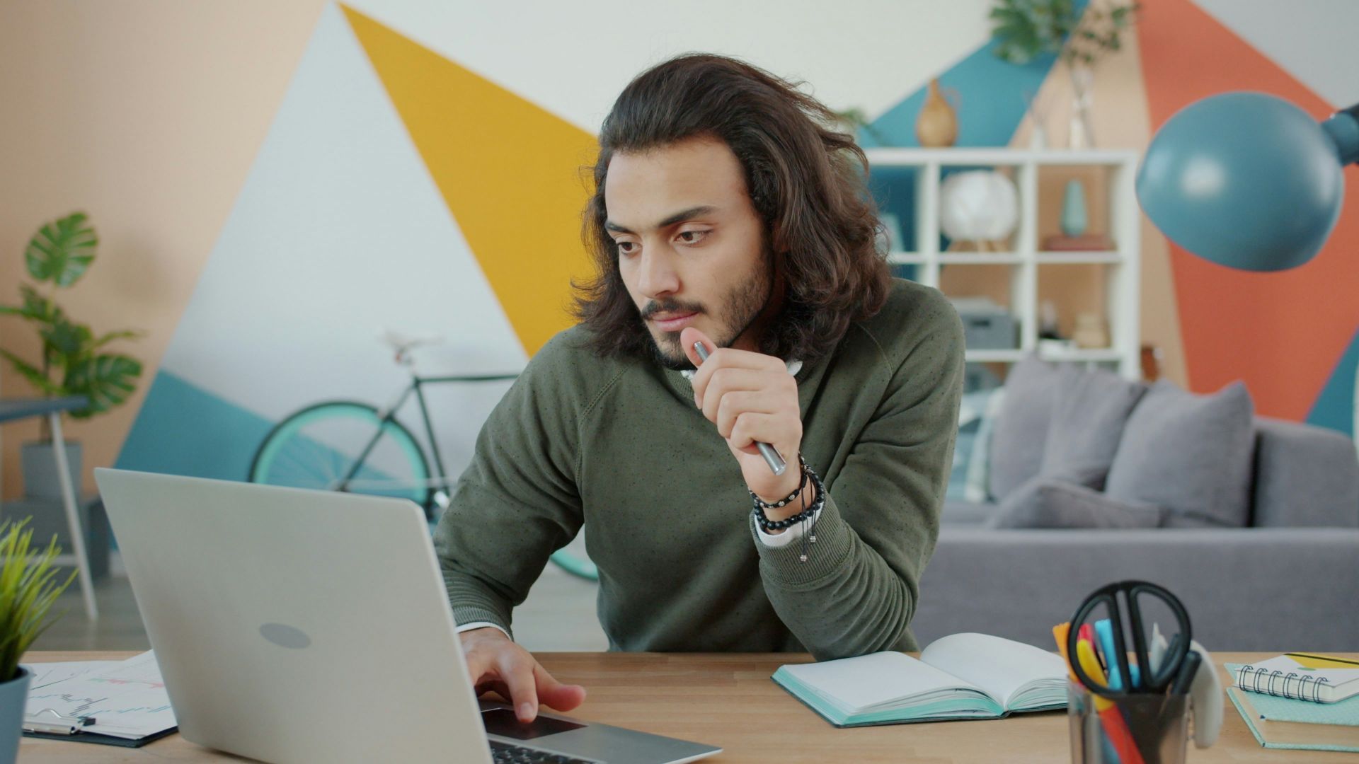 Man working on laptop in colorful modern office