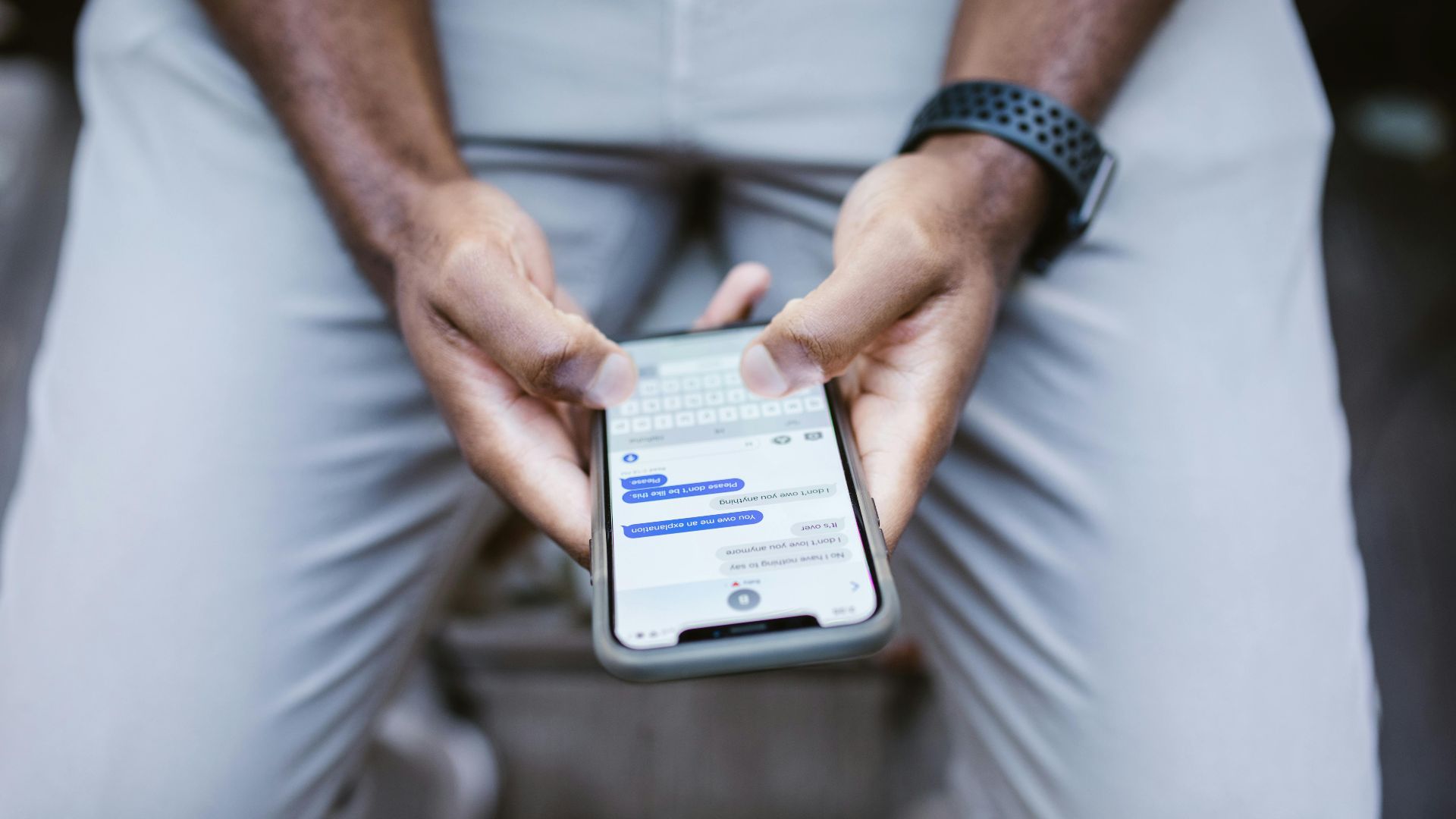 Close-up view of a man texting on a smartphone, capturing communication in action.