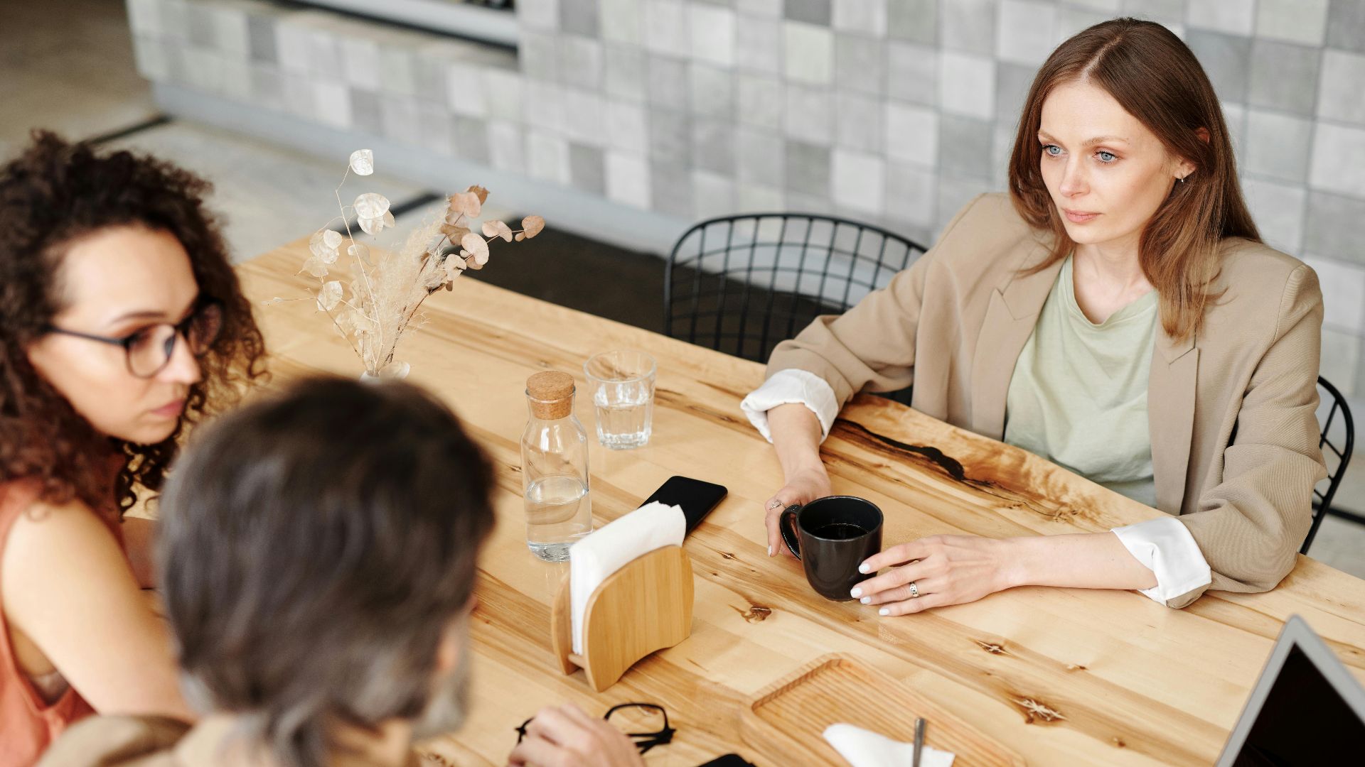 Colleagues having a team discussion at a contemporary café.
