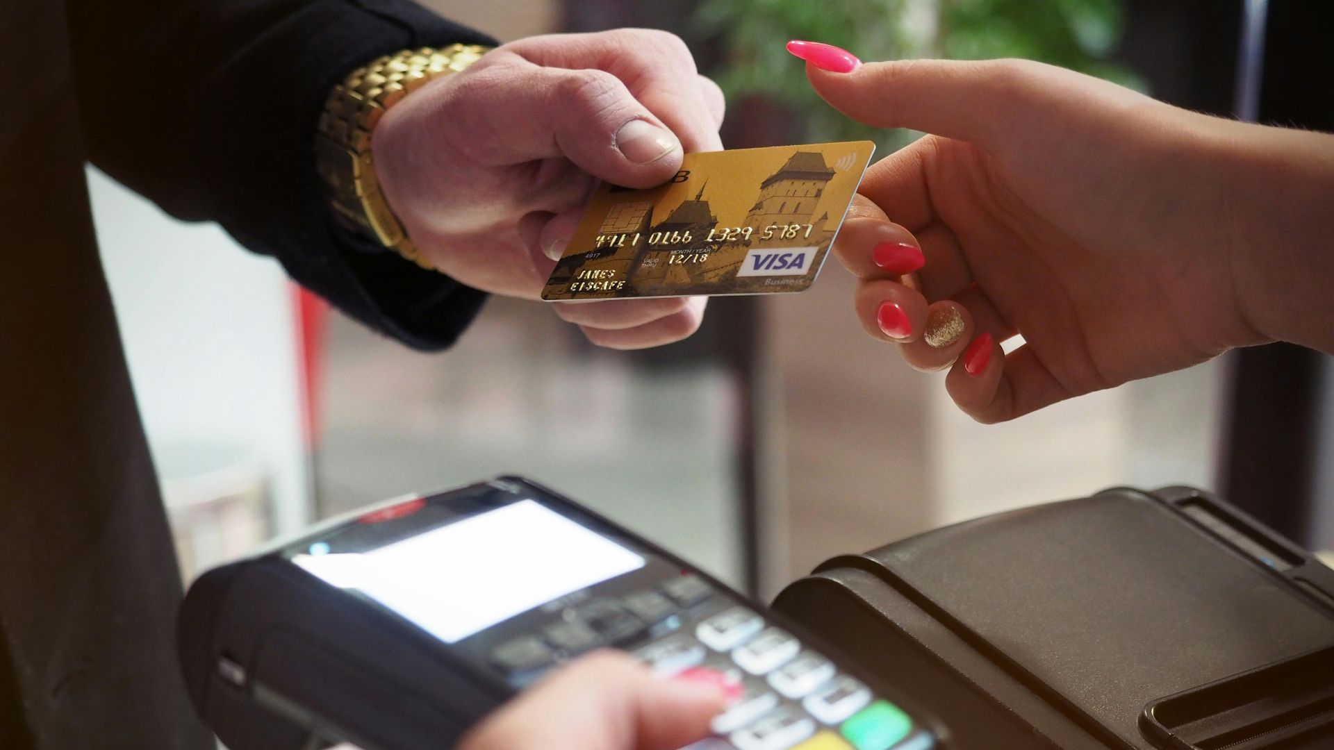 Close-up of a credit card payment being processed at a POS terminal.