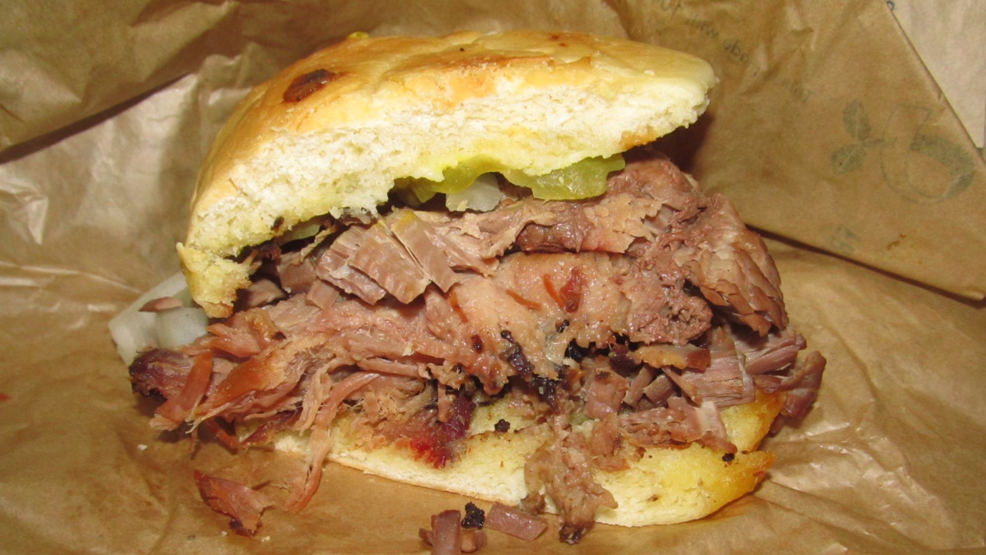 Cut in half to show how much brisket in sandwich