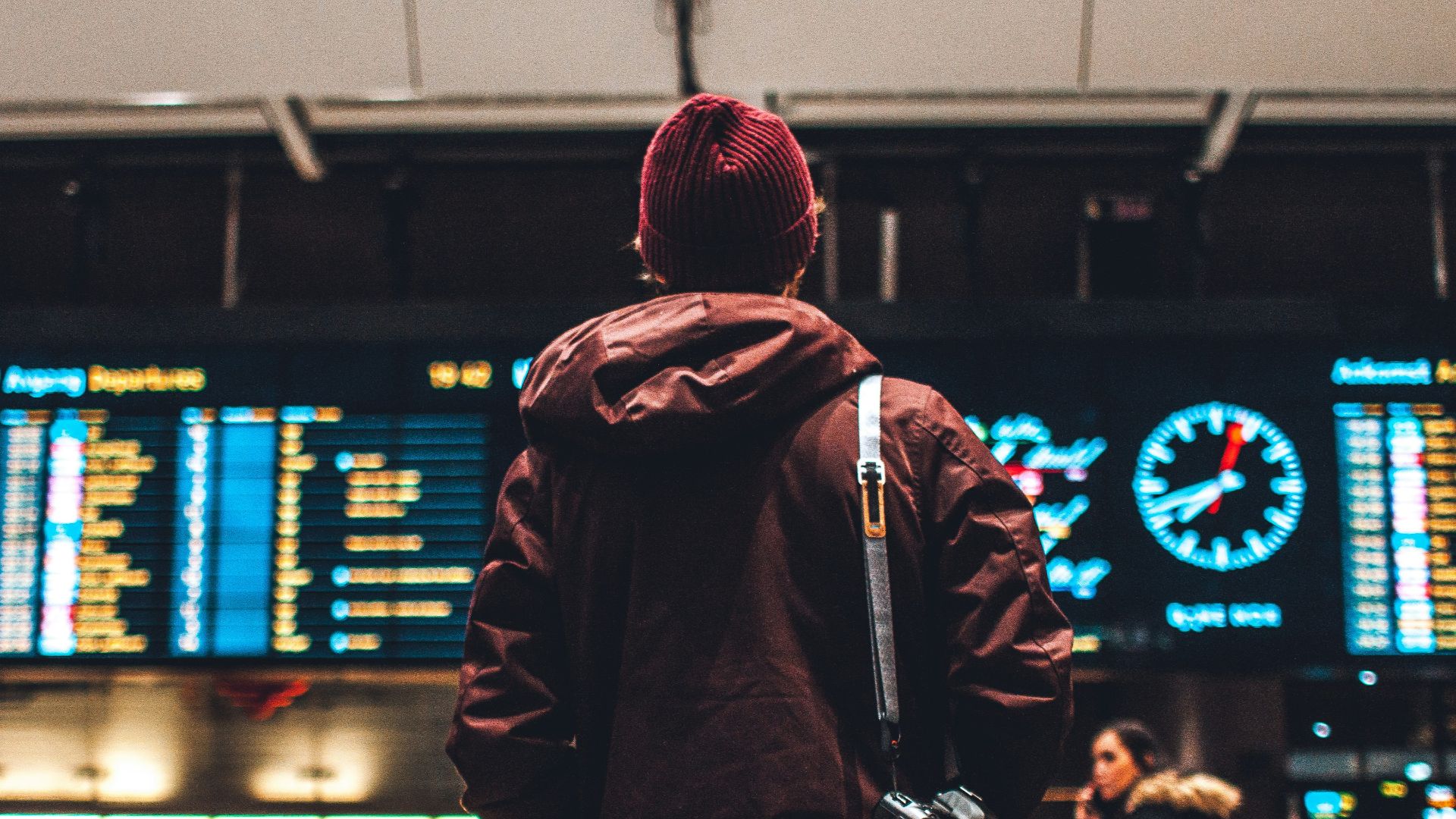 person looking up to the flight schedules
