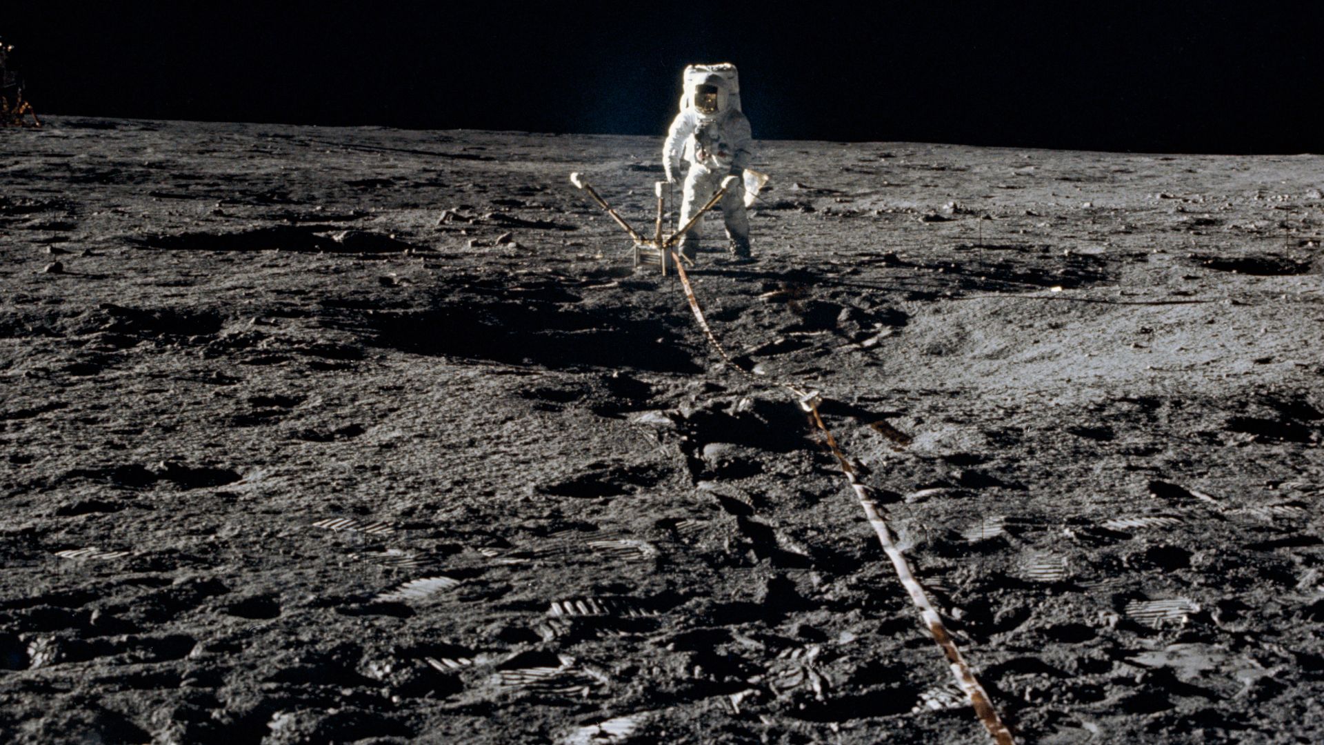 Astronaut Alan L. Bean, lunar module pilot, deploys the Lunar Surface Magnetometer (LSM) during the first Apollo 12 extravehicular activity on the Moon. The LSM is a component of the Apollo Lunar Surface Experiments Package (ALSEP). The Lunar Module can b