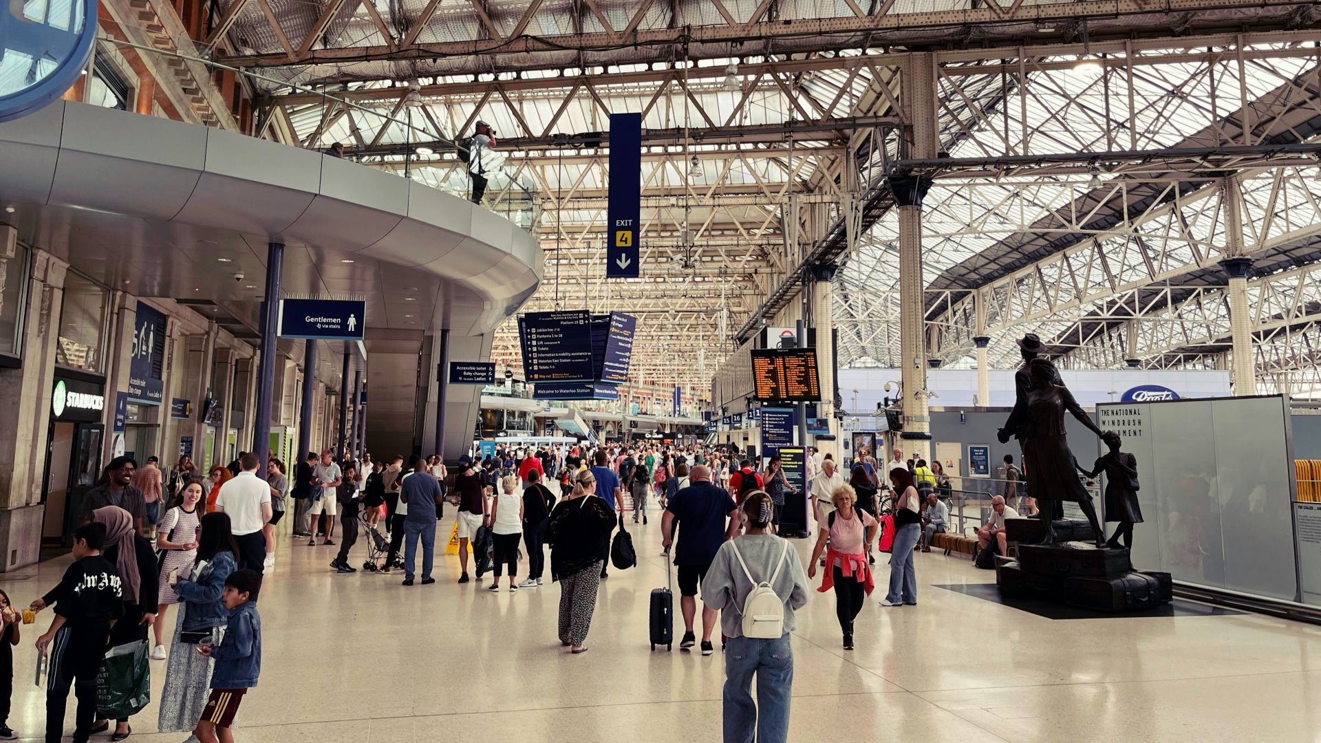a large crowd stands in a large building