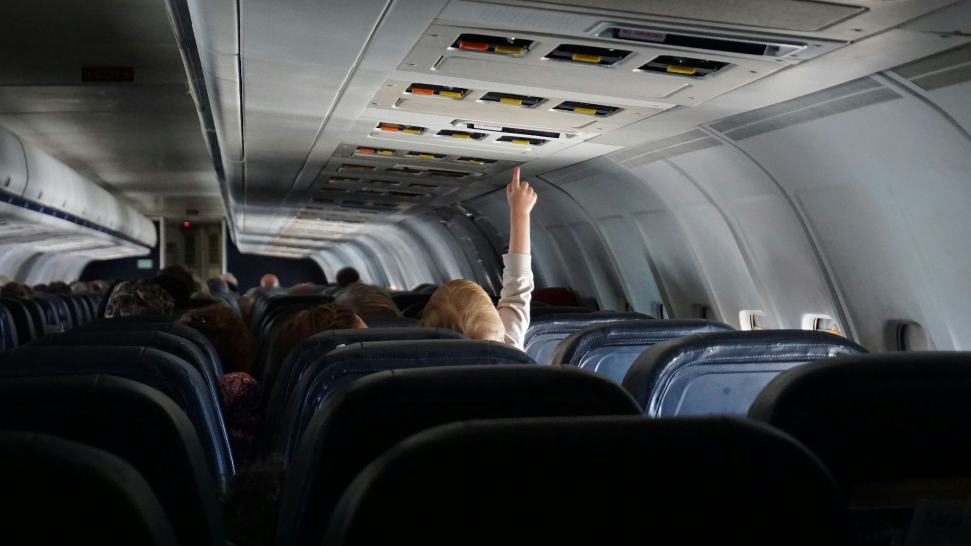 woman raising her hand on passenger seat