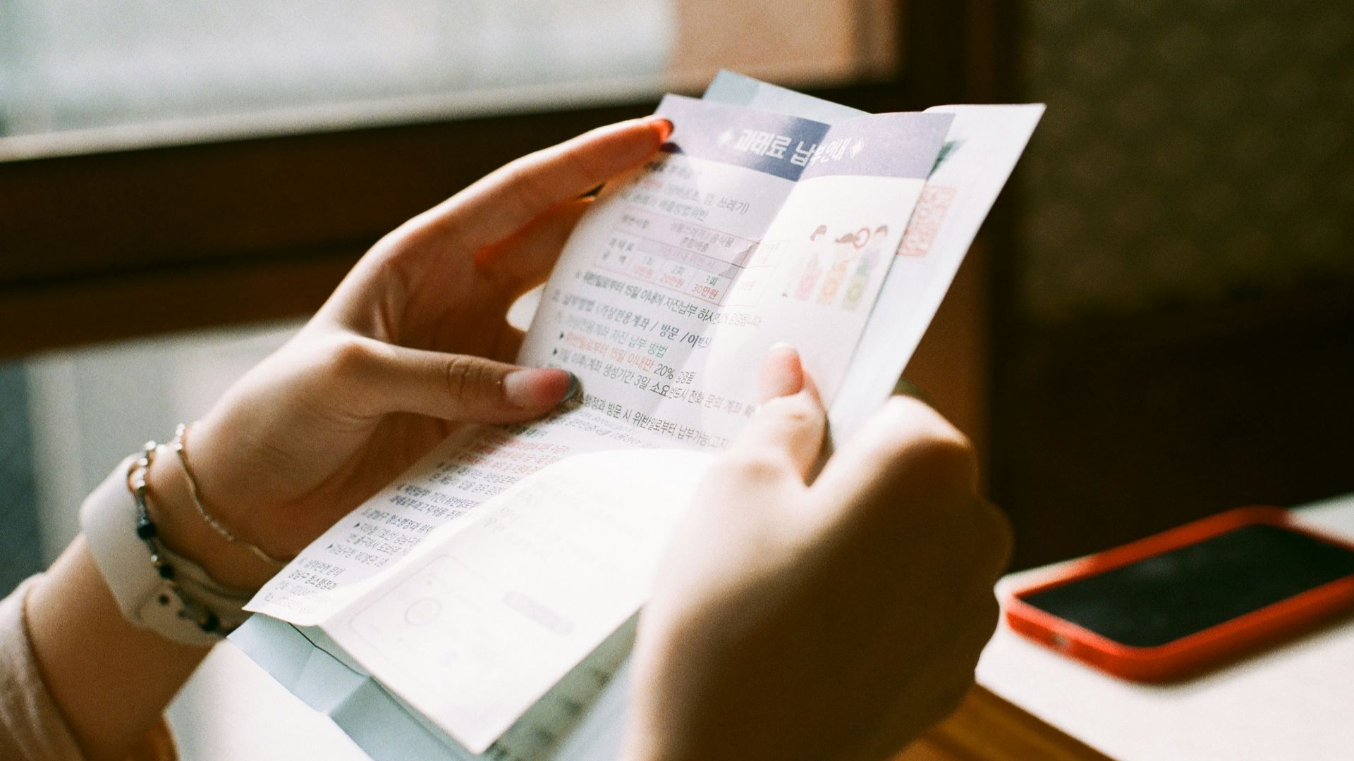 person holding white printer paper