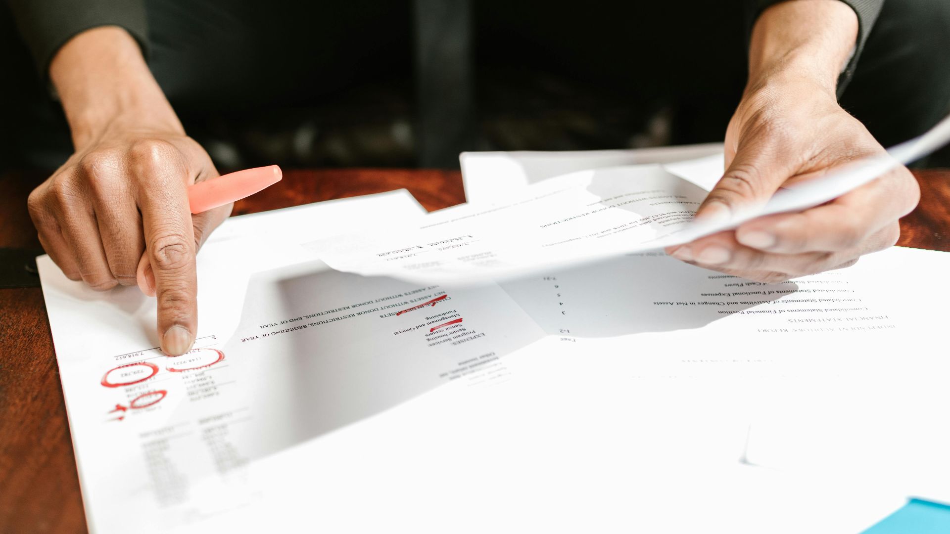 A businessman analyzing financial documents with important data and figures on a desk, ideal for business analytics and accounting themes.