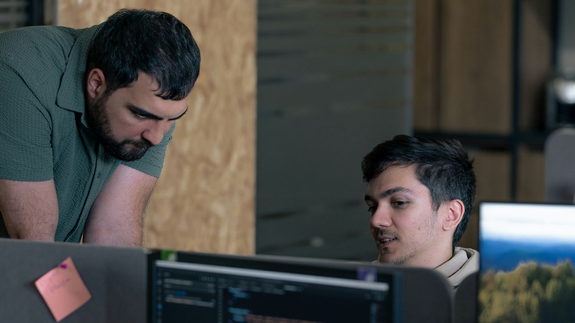 Two men working on computers in an office