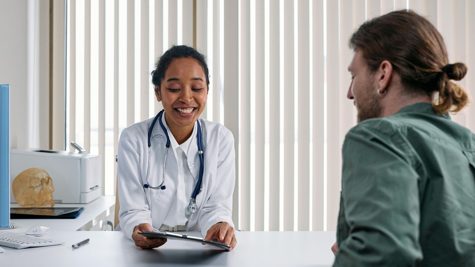 A doctor and patient engaging in a positive consultation in a bright clinic setting.