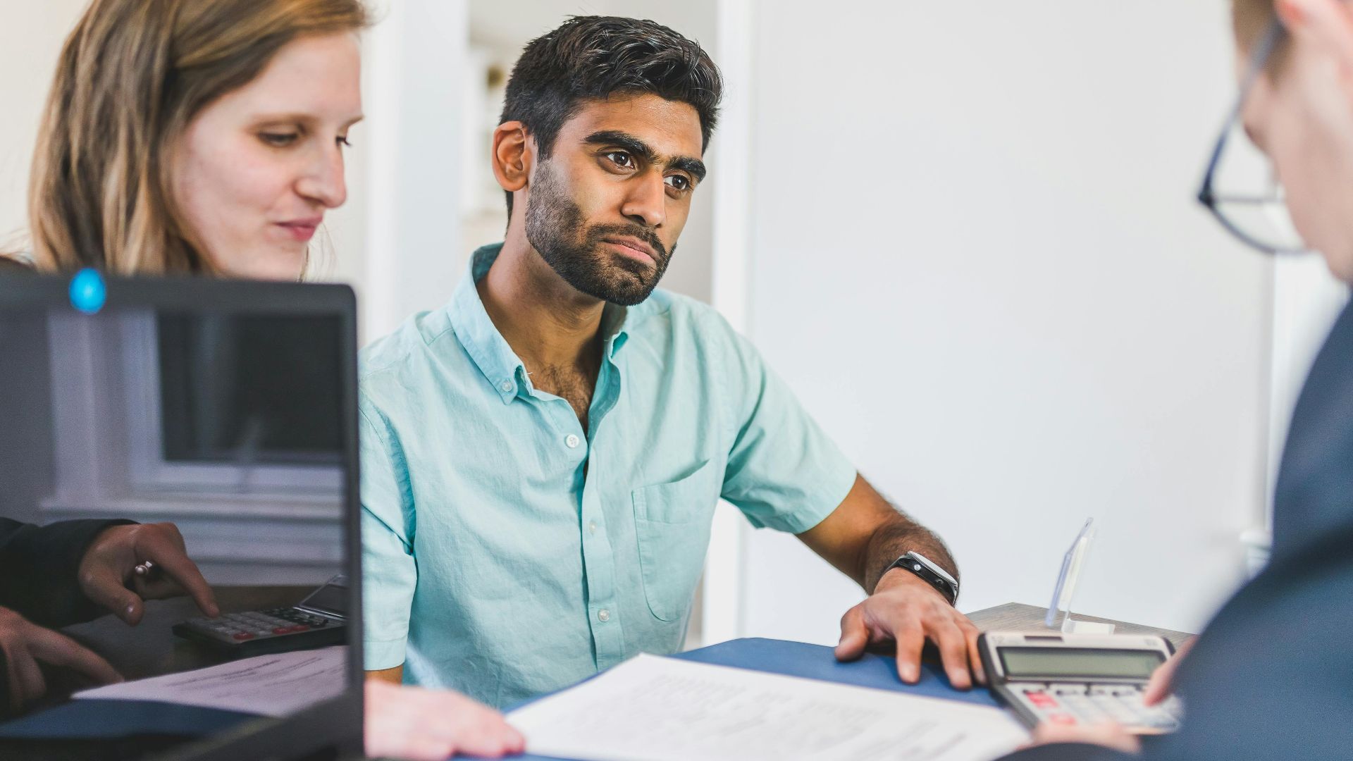 Diverse team discussing business strategies in a modern office setting.