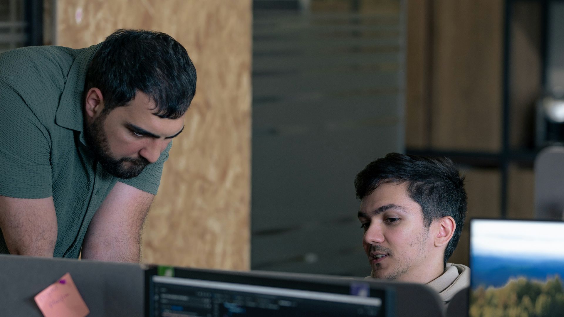 Two men working on computers in an office