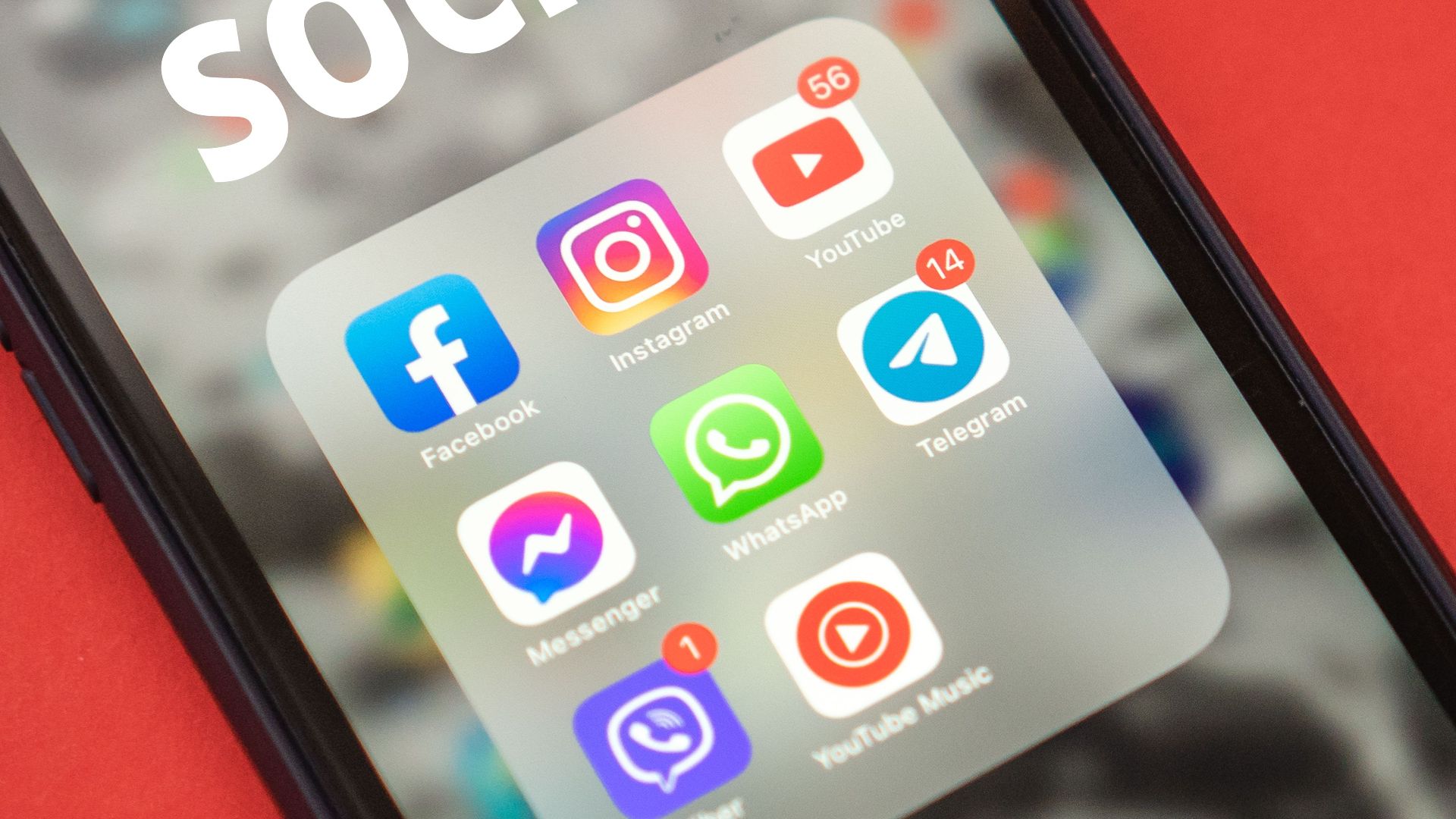 Close-up of a smartphone showing popular social media apps on screen.