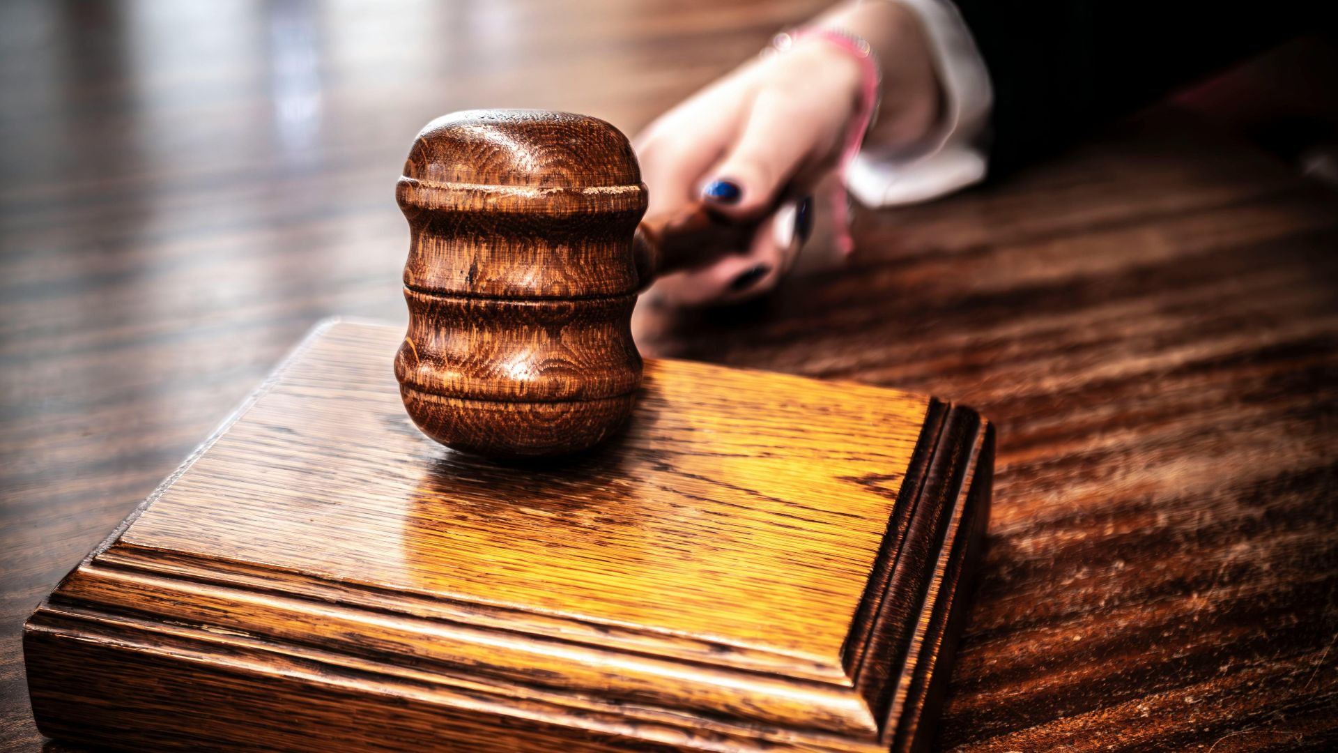 A detailed shot of a wooden gavel on a judge's table, symbolizing justice.