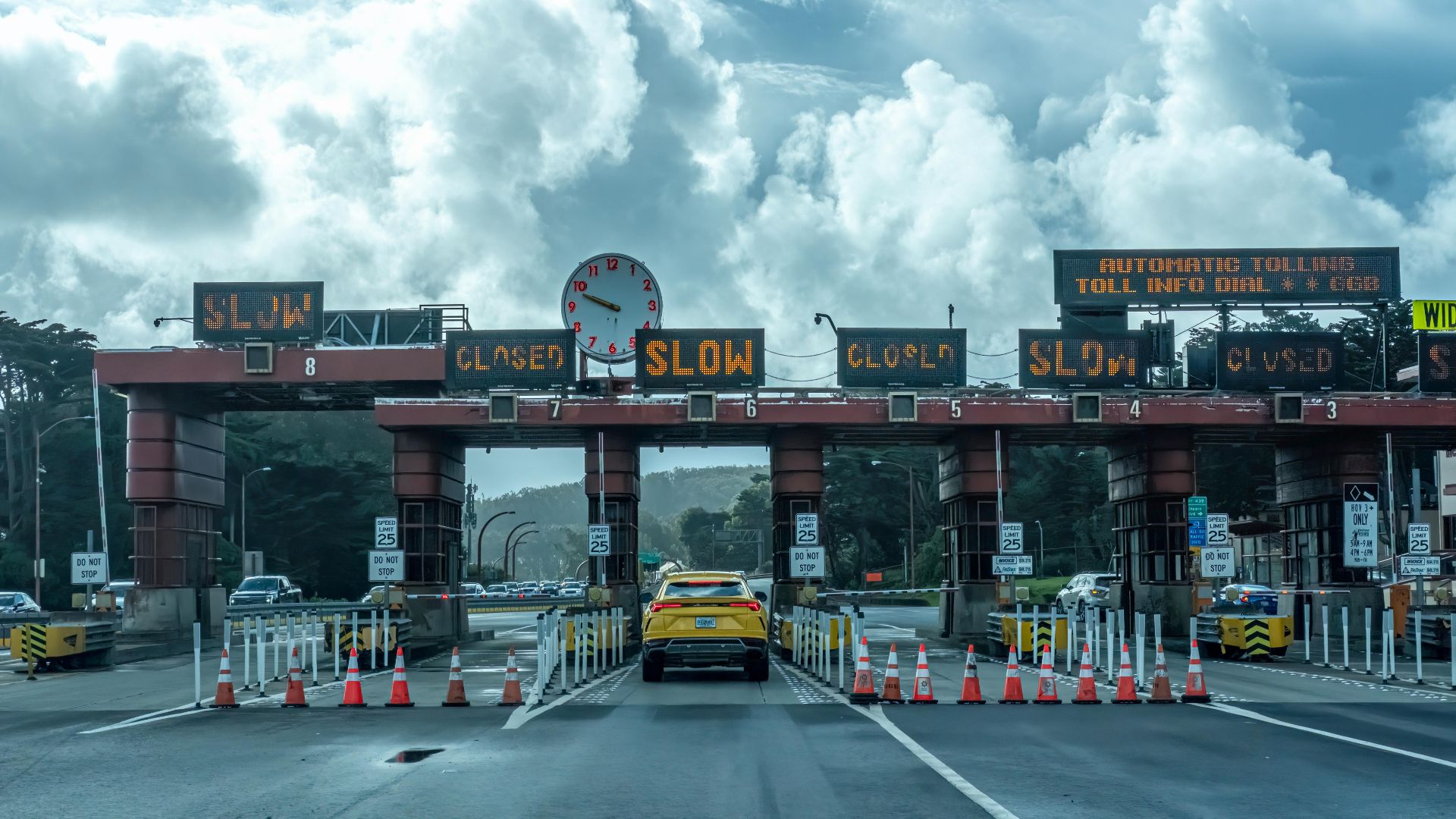 View of vehicles approaching the toll plaza at Golden Gate Bridge in San Francisco under a cloudy sky.