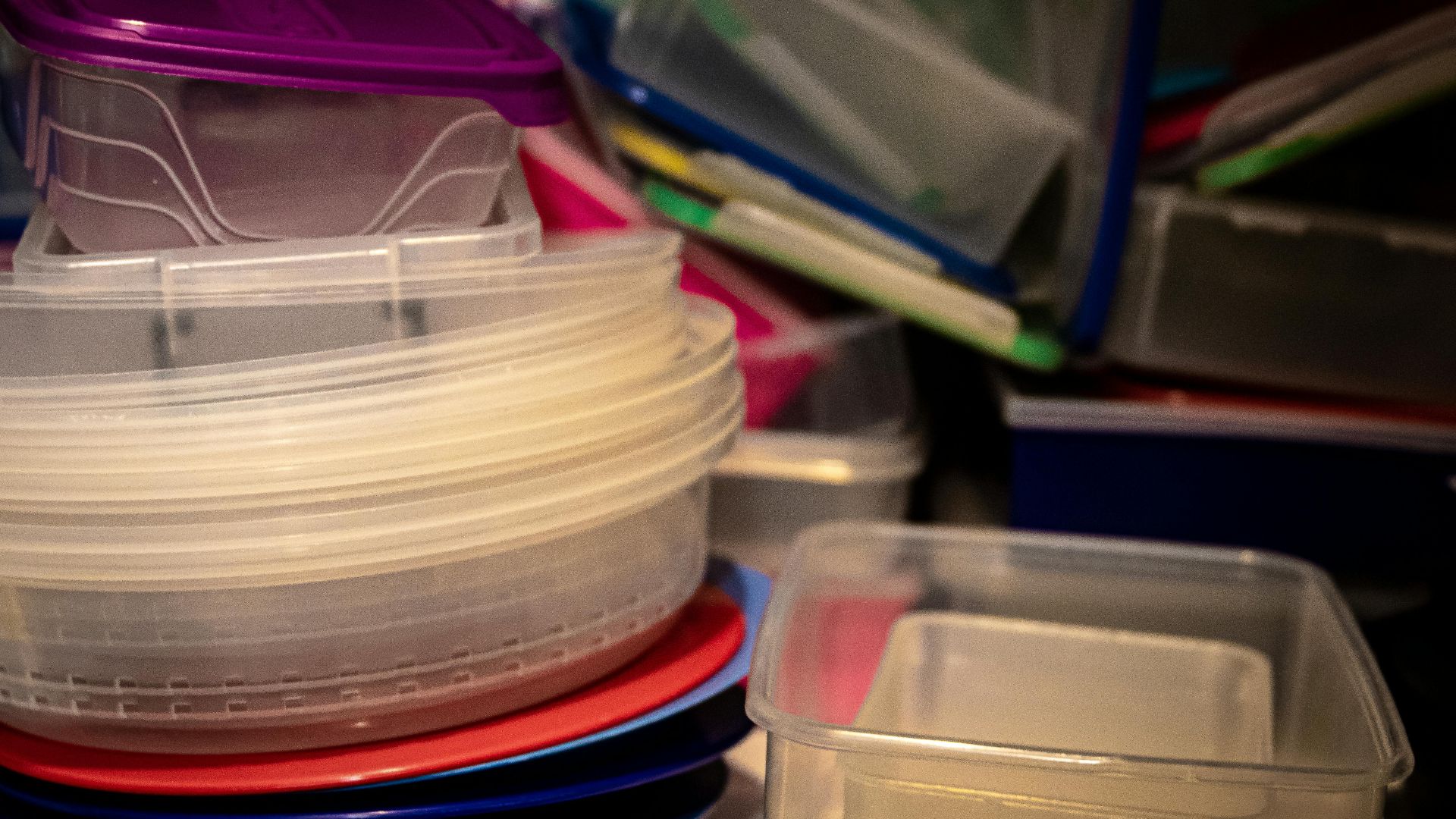A variety of plastic storage containers stacked together, ideal for organizing kitchen spaces.