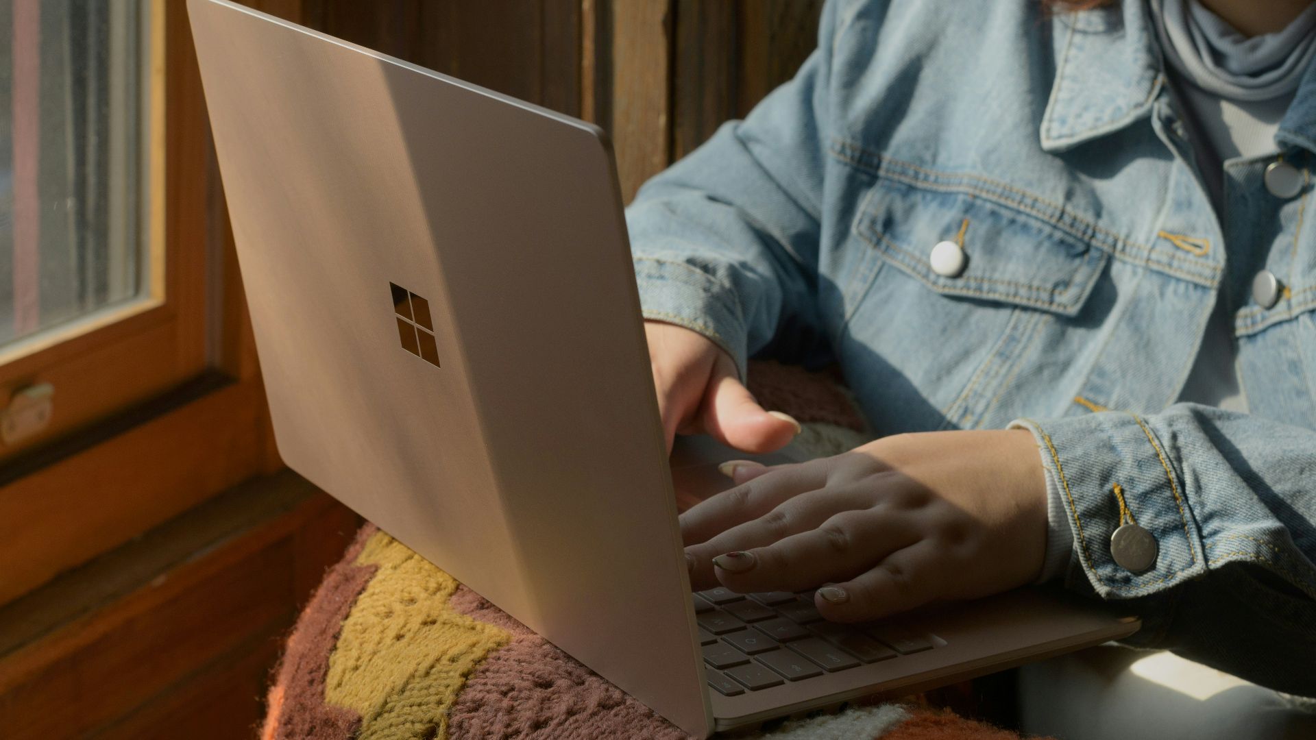 a woman sitting in a chair using a laptop computer
