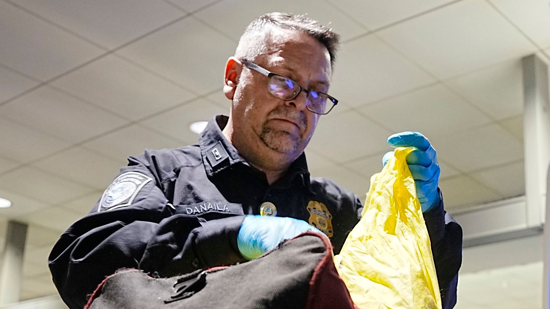 A U.S. Customs and Border Protection Office of Field Operations agriculture specialist searches the luggage of international travelers arriving at Baltimore/Washington International Thurgood Marshall Airport February 27, 2025. CBP Photo by Glenn Fawcett