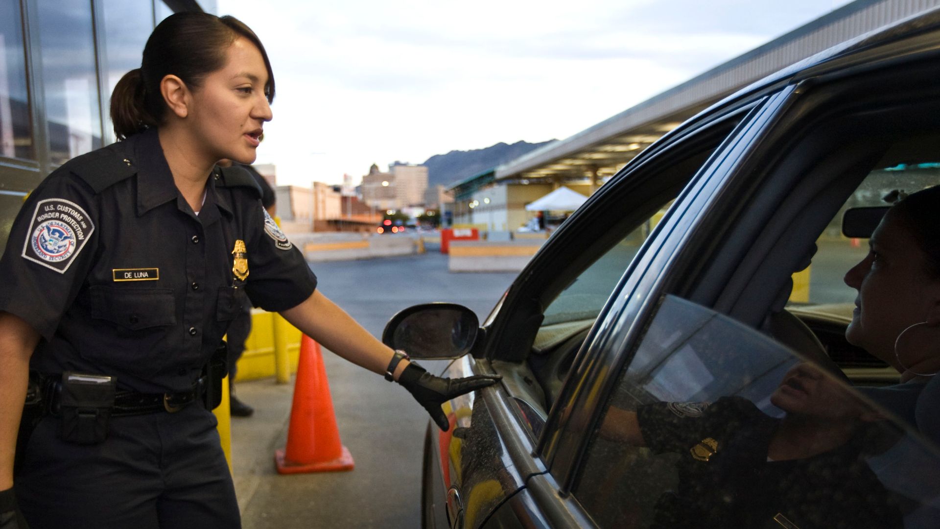 CBP Officer checks vehicles entering the United States at a border crossing point of entry.