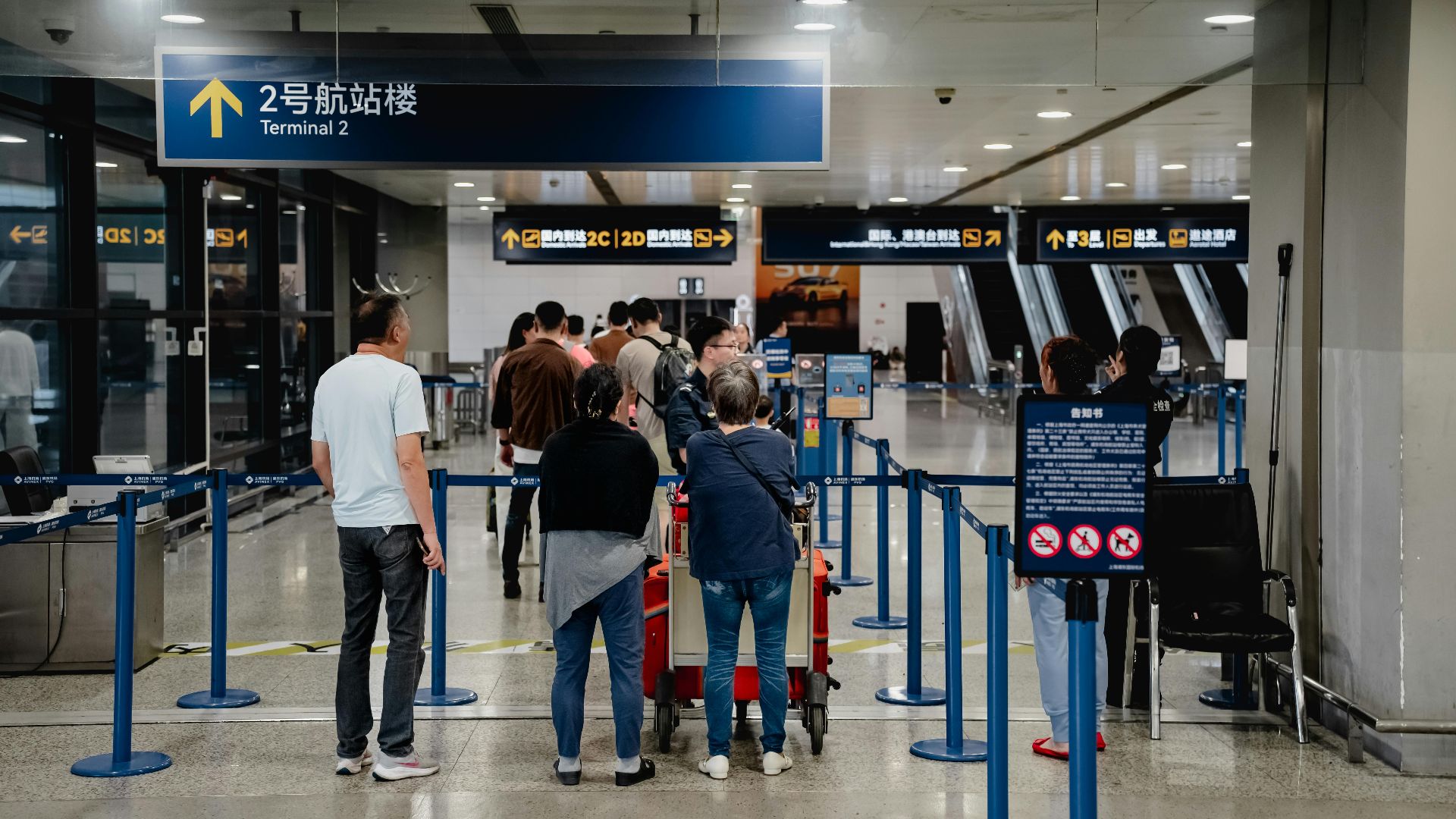 Passengers queue at Terminal 2 in Shanghai Airport, China.