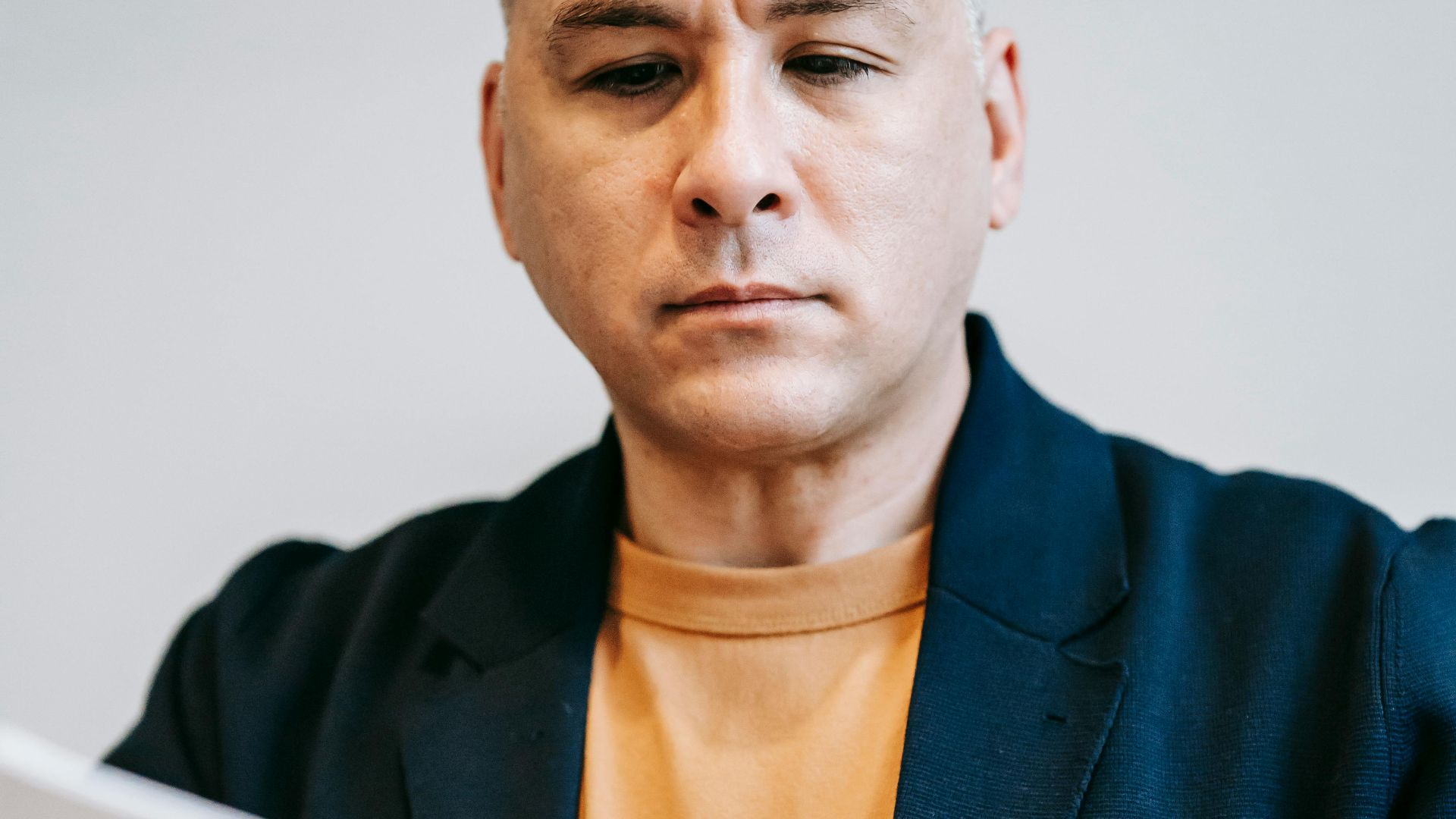 Man concentrating on paperwork in a professional setting, deeply engaged in reviewing documents.