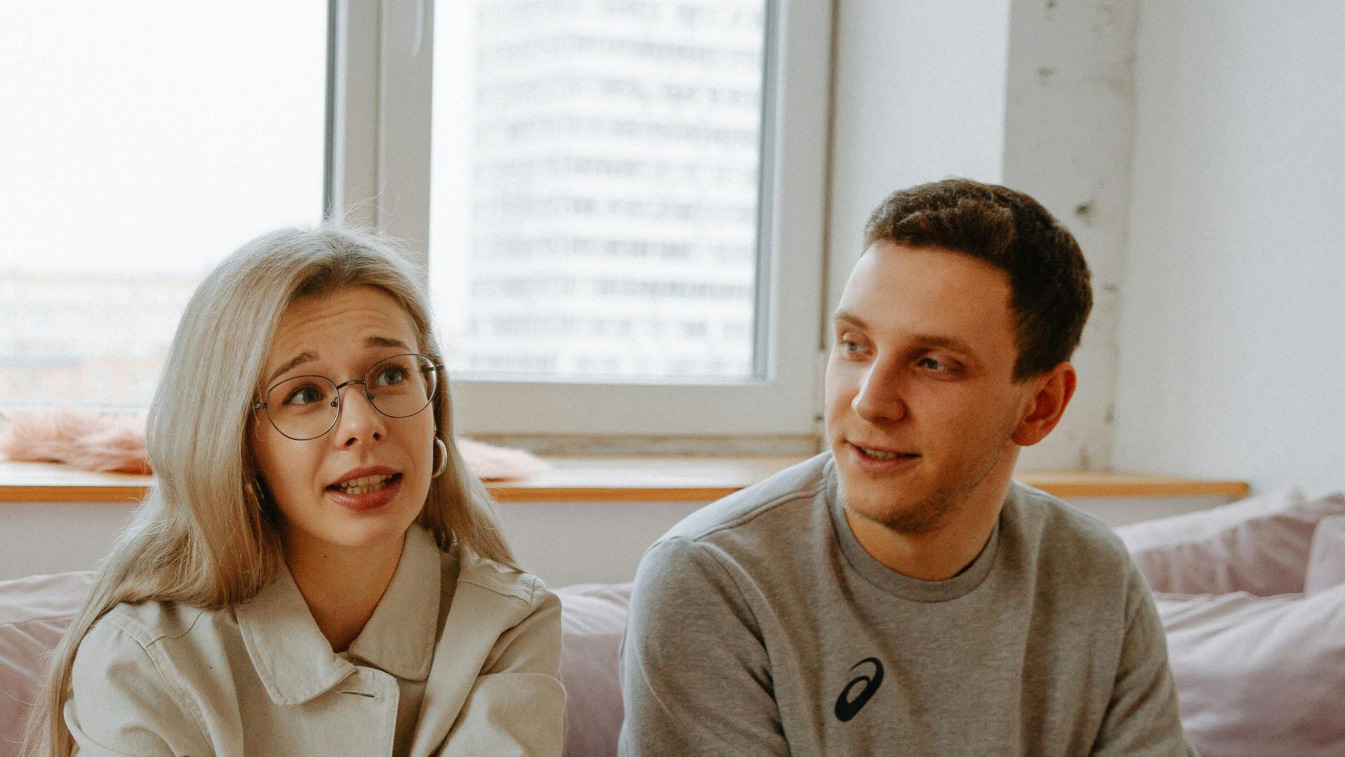 A couple and therapist engaged in a discussion during a therapy session indoors.