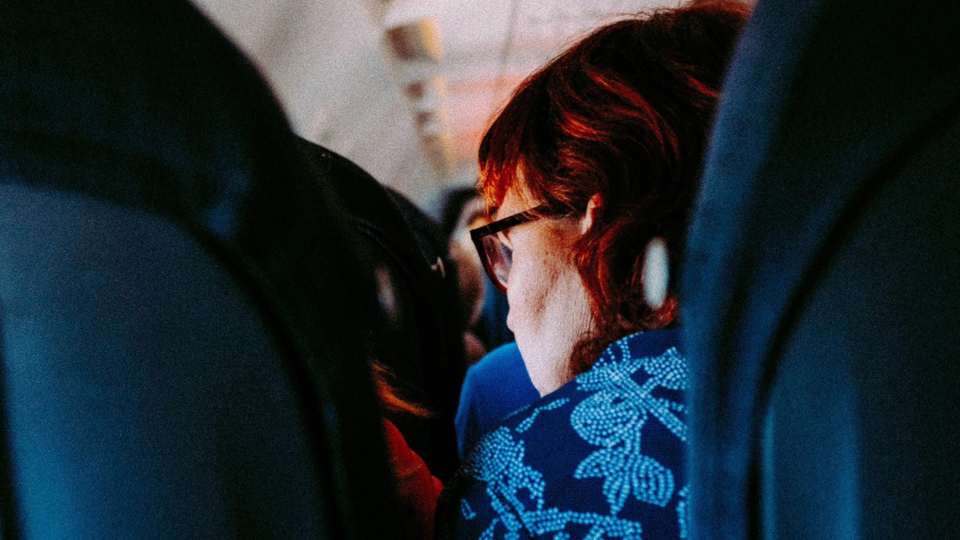 Woman sitting in an airplane cabin interior during daytime travel.