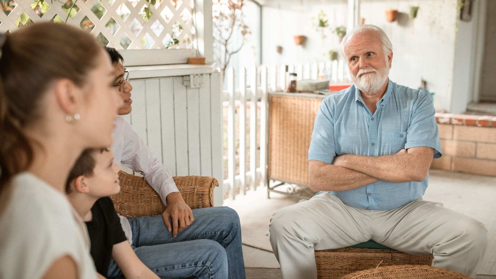 Family gathered indoors, engaged in conversation with a focus on bonds and togetherness.