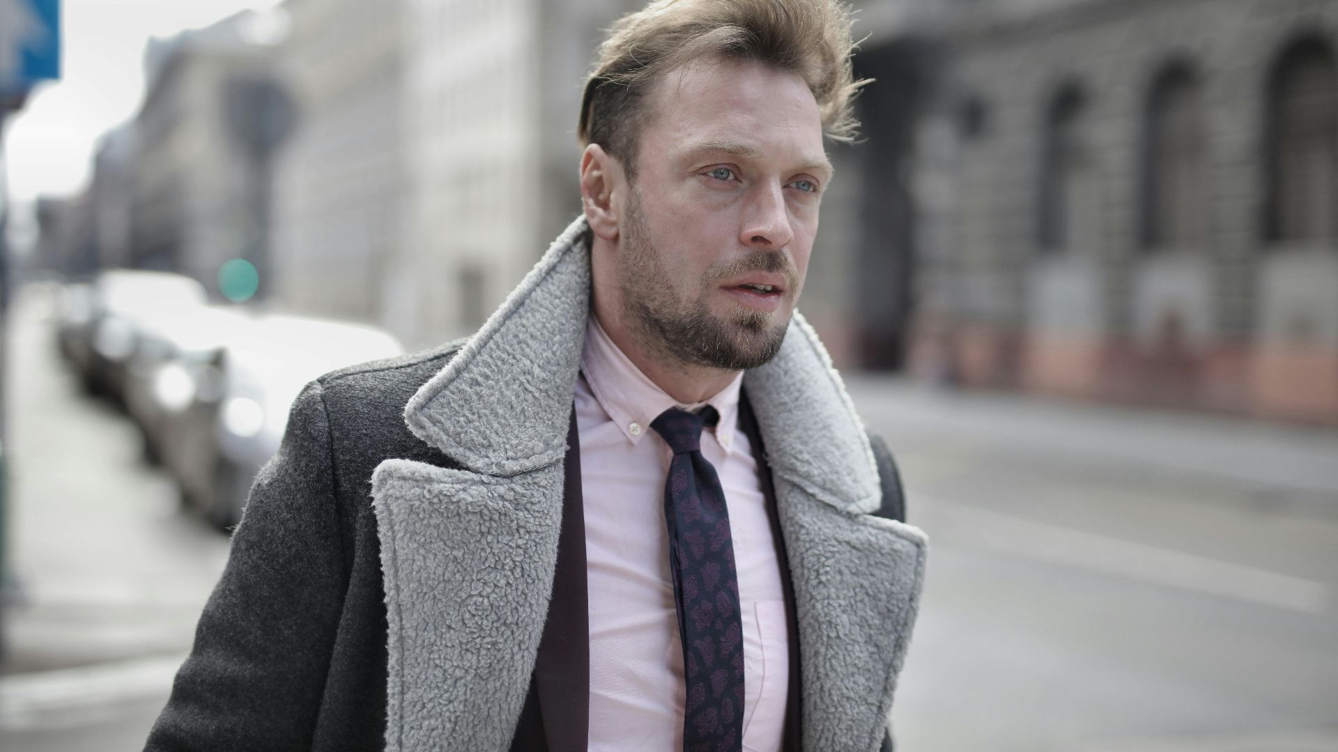 Portrait of a fashionable man in urban street setting on an overcast day.