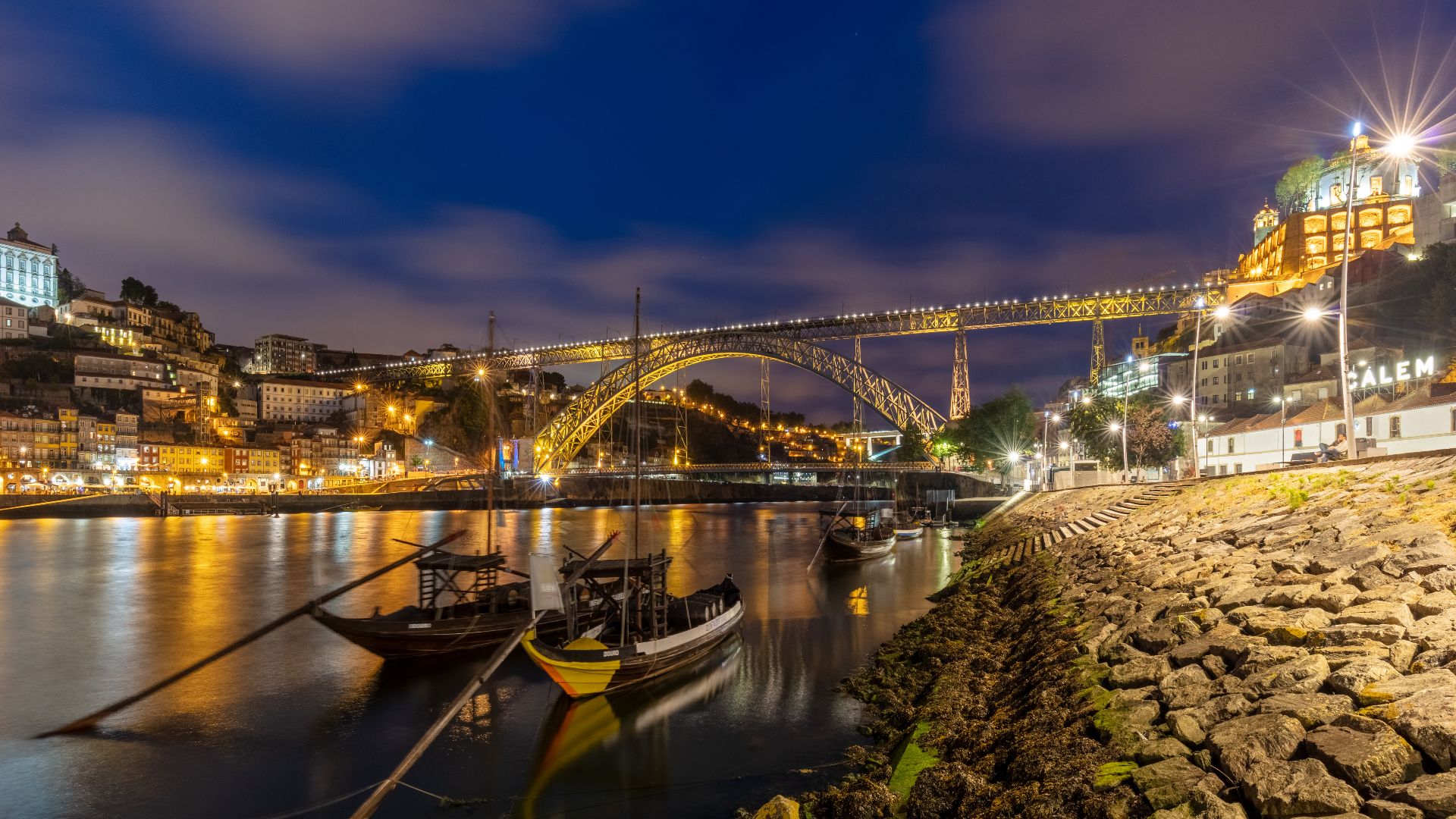 View during the blue hour of the Dom Luís I Bridge and the city of Porto, Portugal. The bridge, built between 1881 and 1886 spans the Douro River to connect Porto with Vila Nova de Gaia.