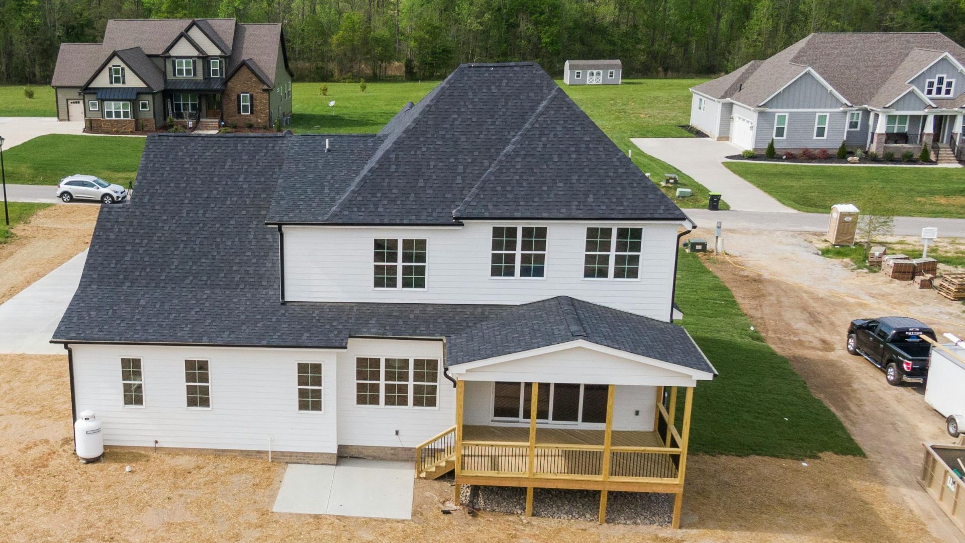 Aerial shot of a suburban home under construction in Youngsville, NC with surrounding greenery.