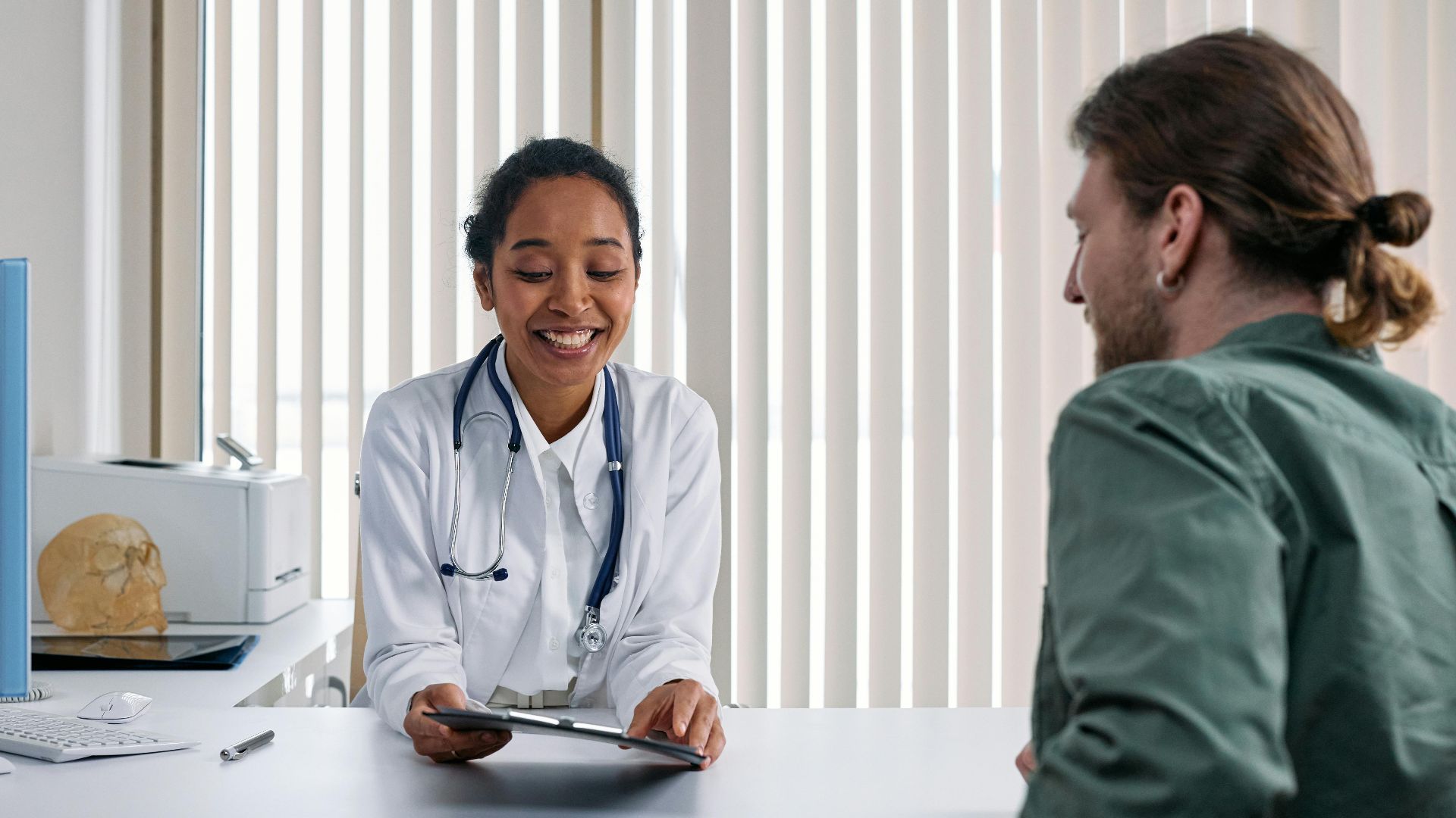 A doctor and patient engaging in a positive consultation in a bright clinic setting.