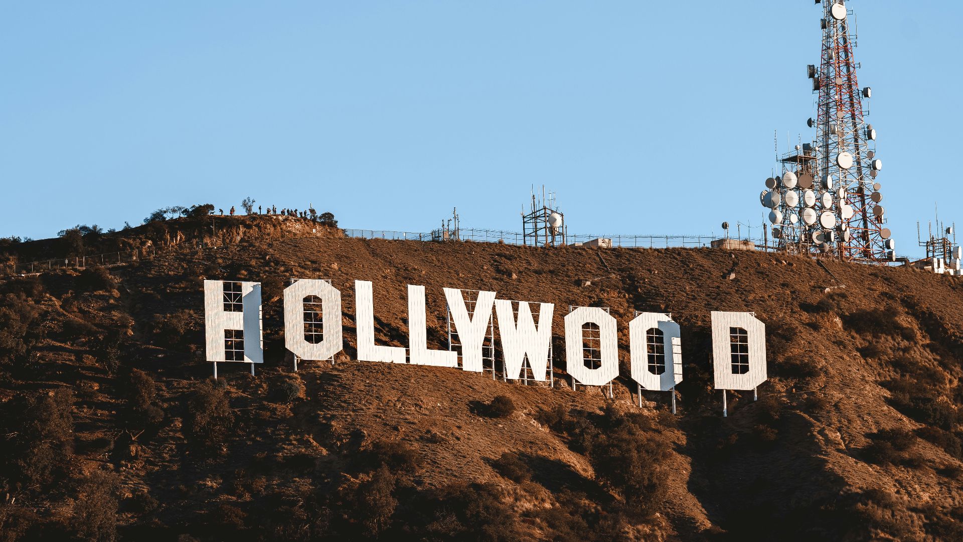 the hollywood sign is covered in dirt on top of a hill