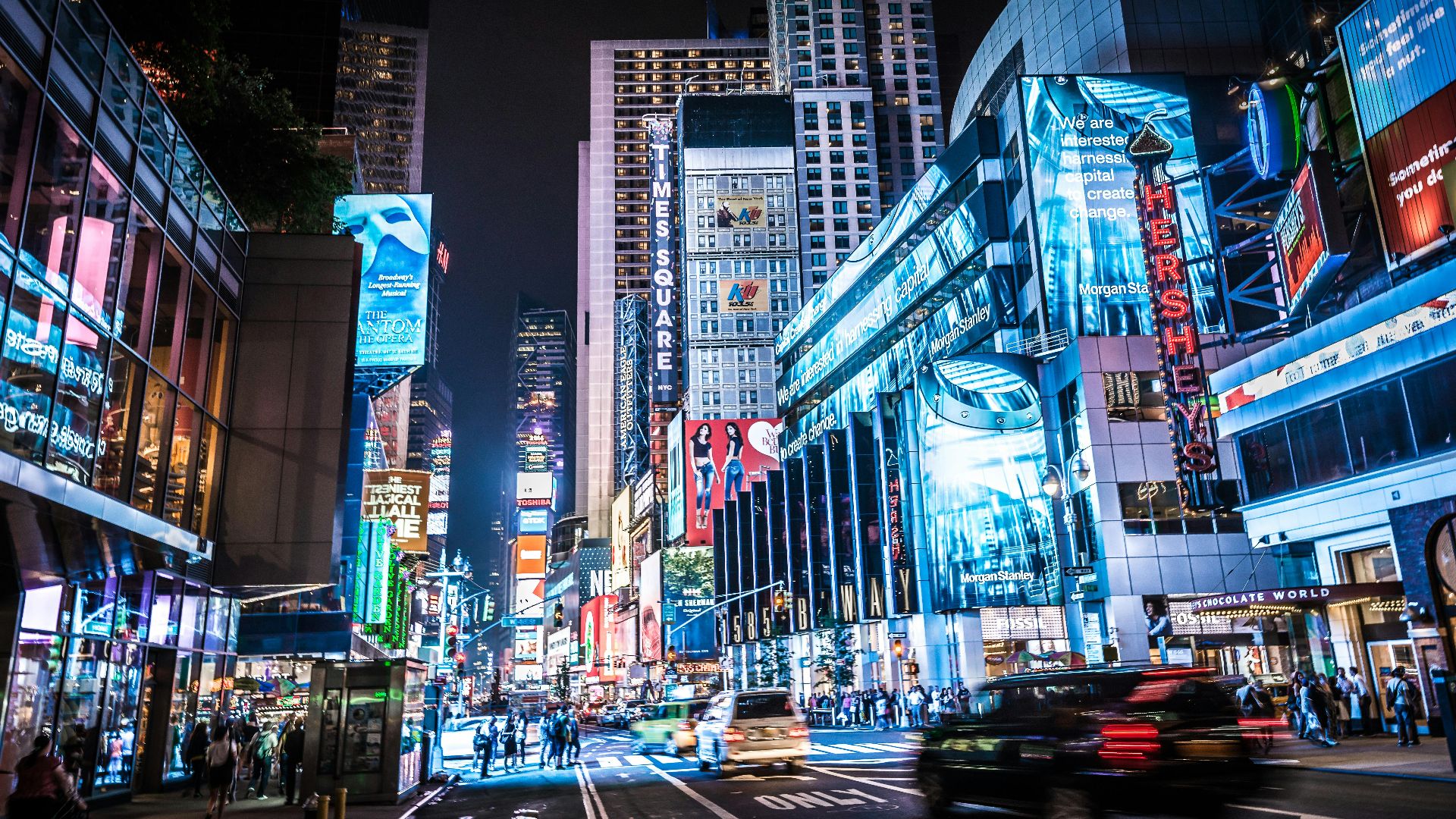 Experience the bustling city life of Times Square, New York City, captured at night in vivid colors and lights.