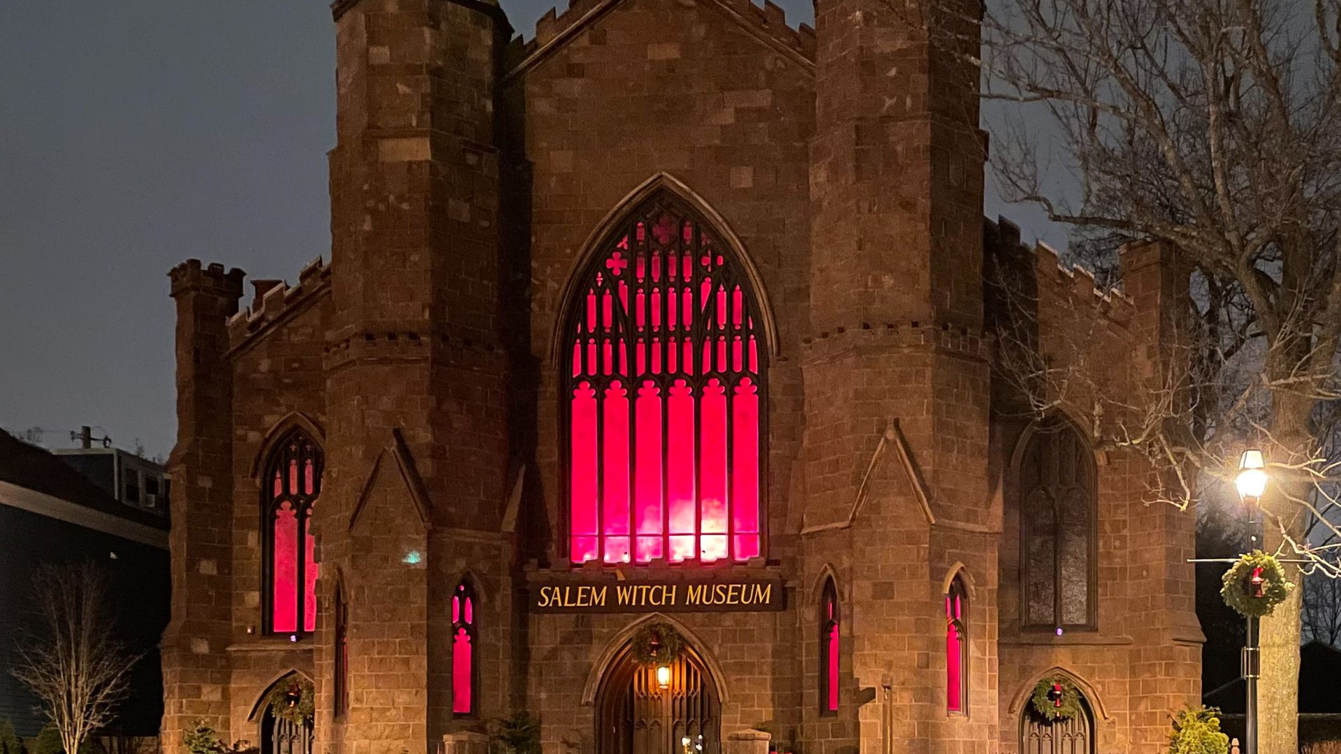 The Witch Museum in Salem, Massachusetts, shortly after dusk, in January 2021. It is still adorned with its holiday decorations.