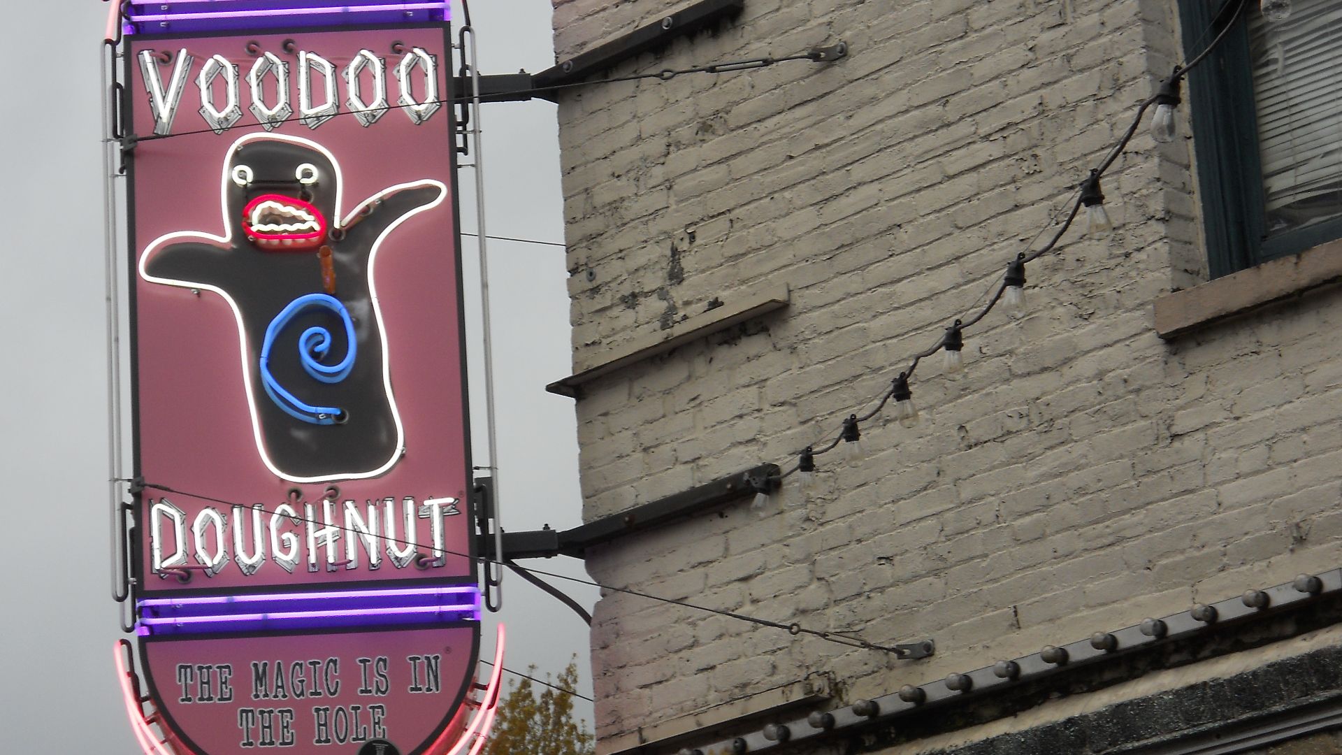 The neon sign for the Voodoo Doughnut restaurant in Portland, Oregon.