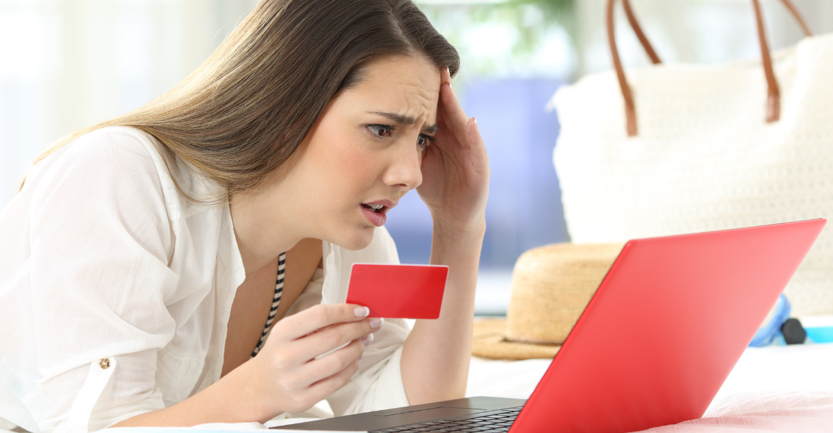 Worried guest having problems buying on line with credit card and a laptop in an hotel room during a travel on summer vacations