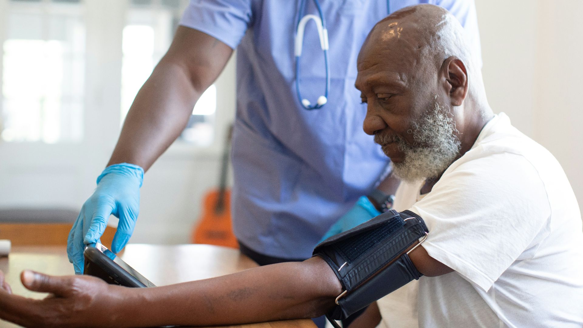 a doctor checking a patient's blood pressure