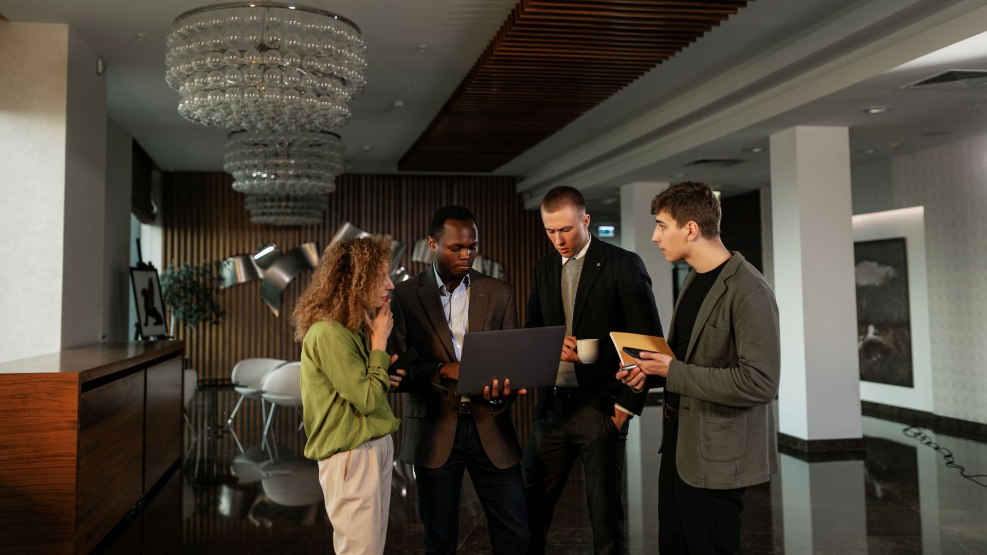 Group of diverse professionals discussing ideas in a modern office setting.
