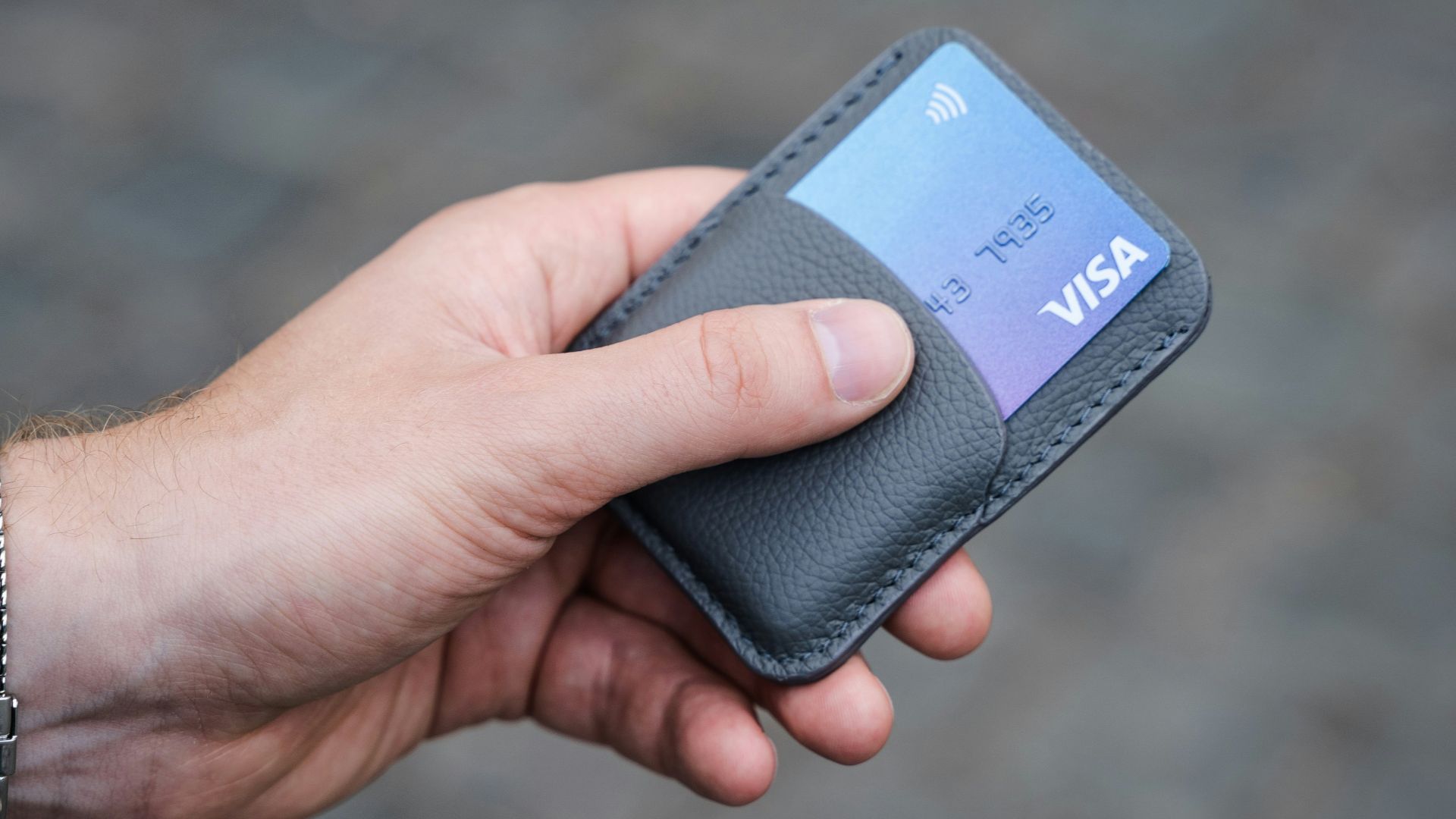 a person holding a credit card in their hand