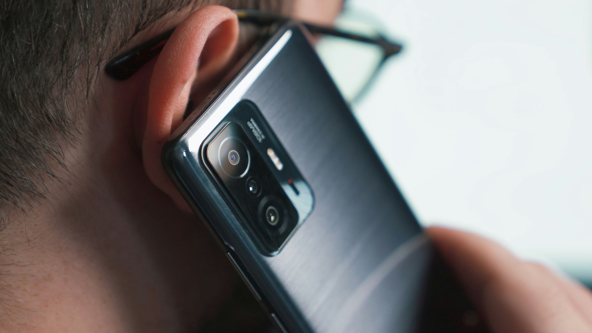 a close up of a person talking on a cell phone