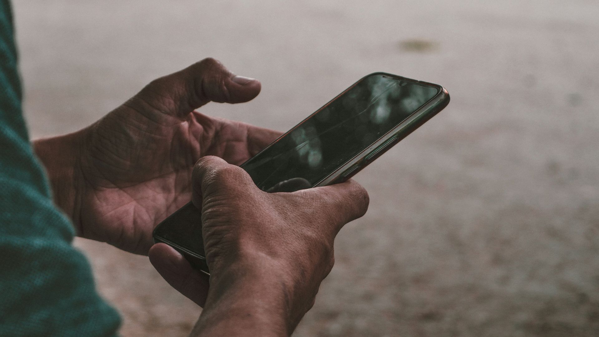 a person holding a cell phone in their hands
