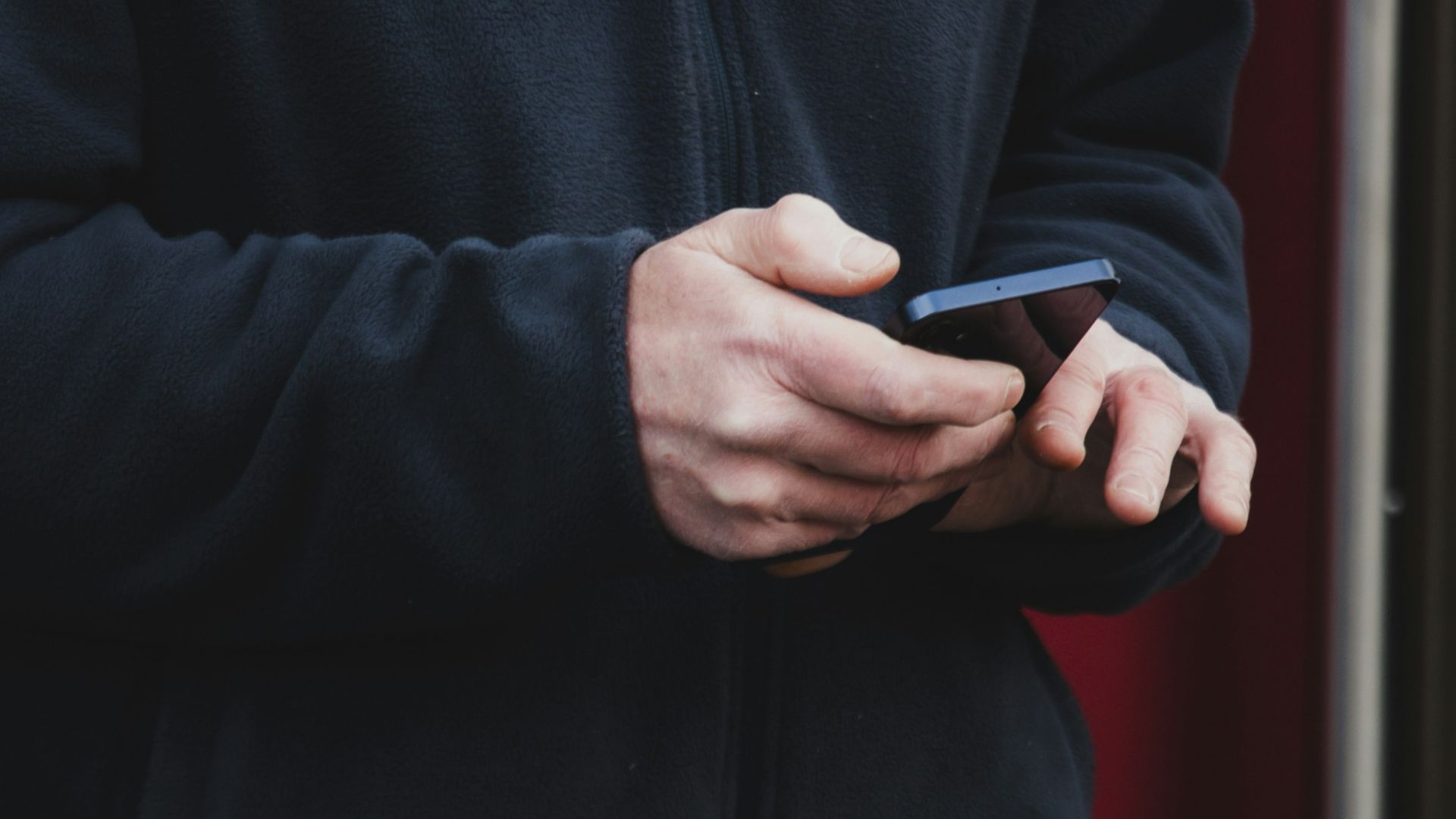 Person's hands holding a smartphone