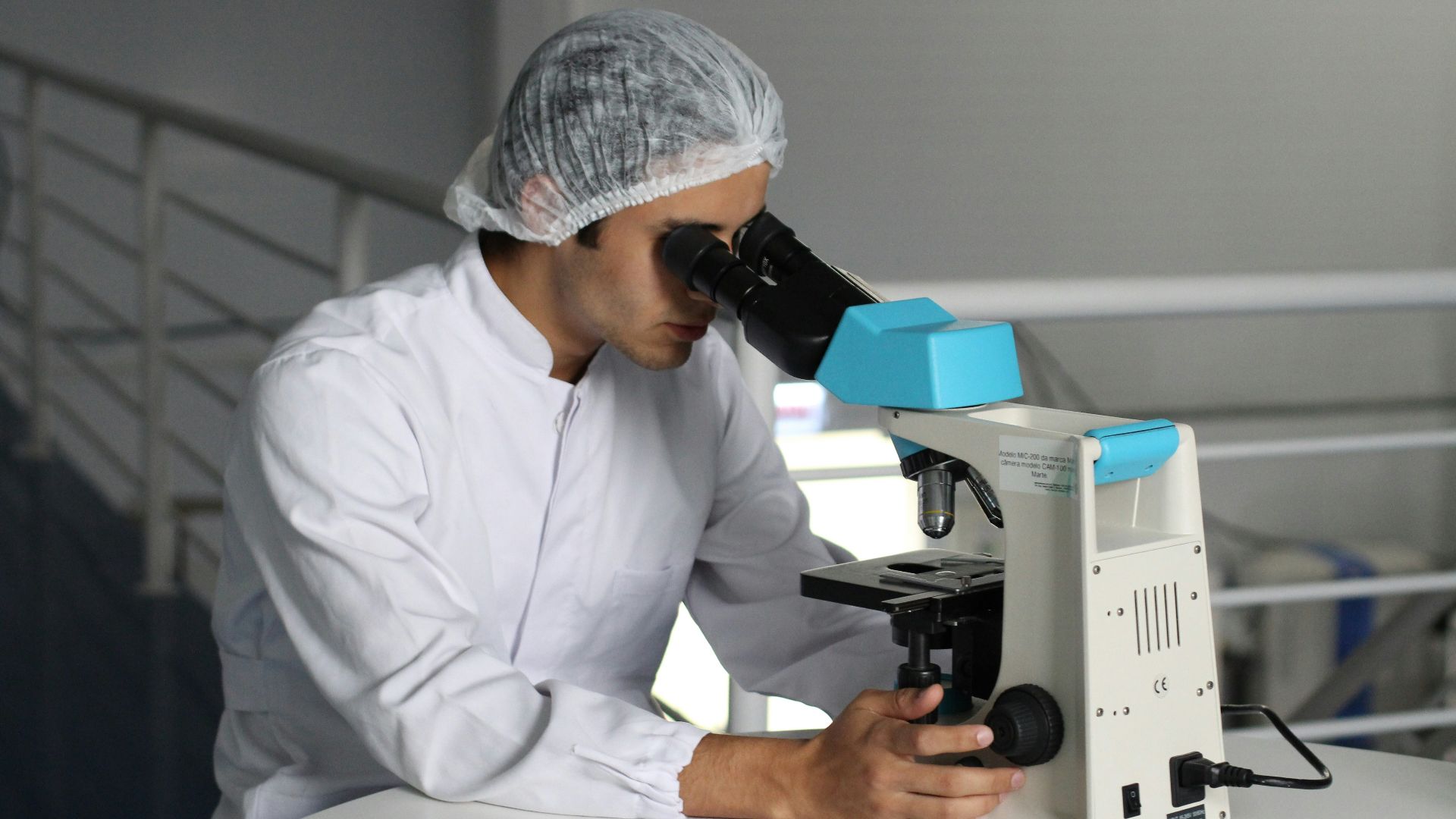 man sight on white microscope